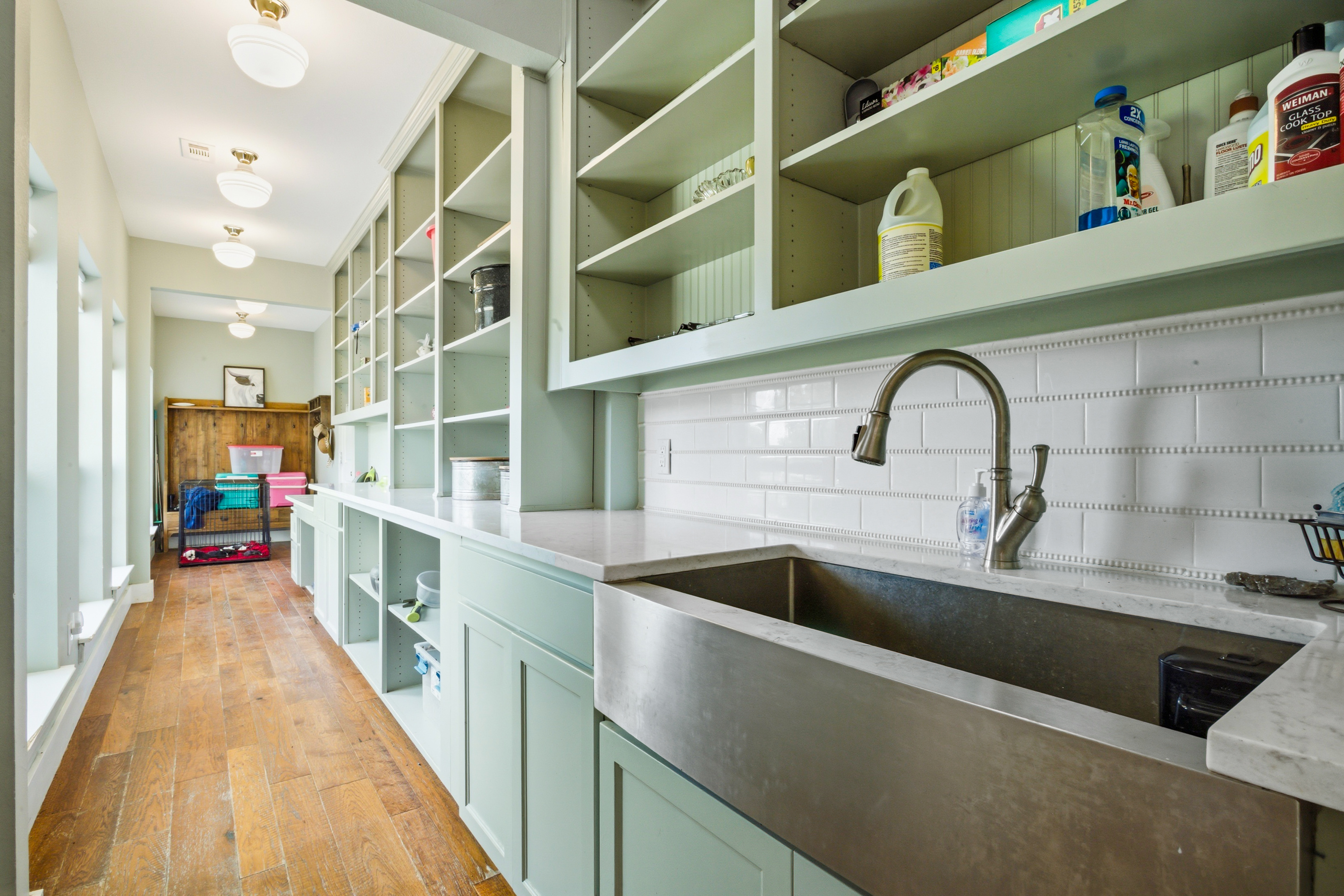 30-foot deep butler's pantry with sage green custom cabinetry and quartz counters