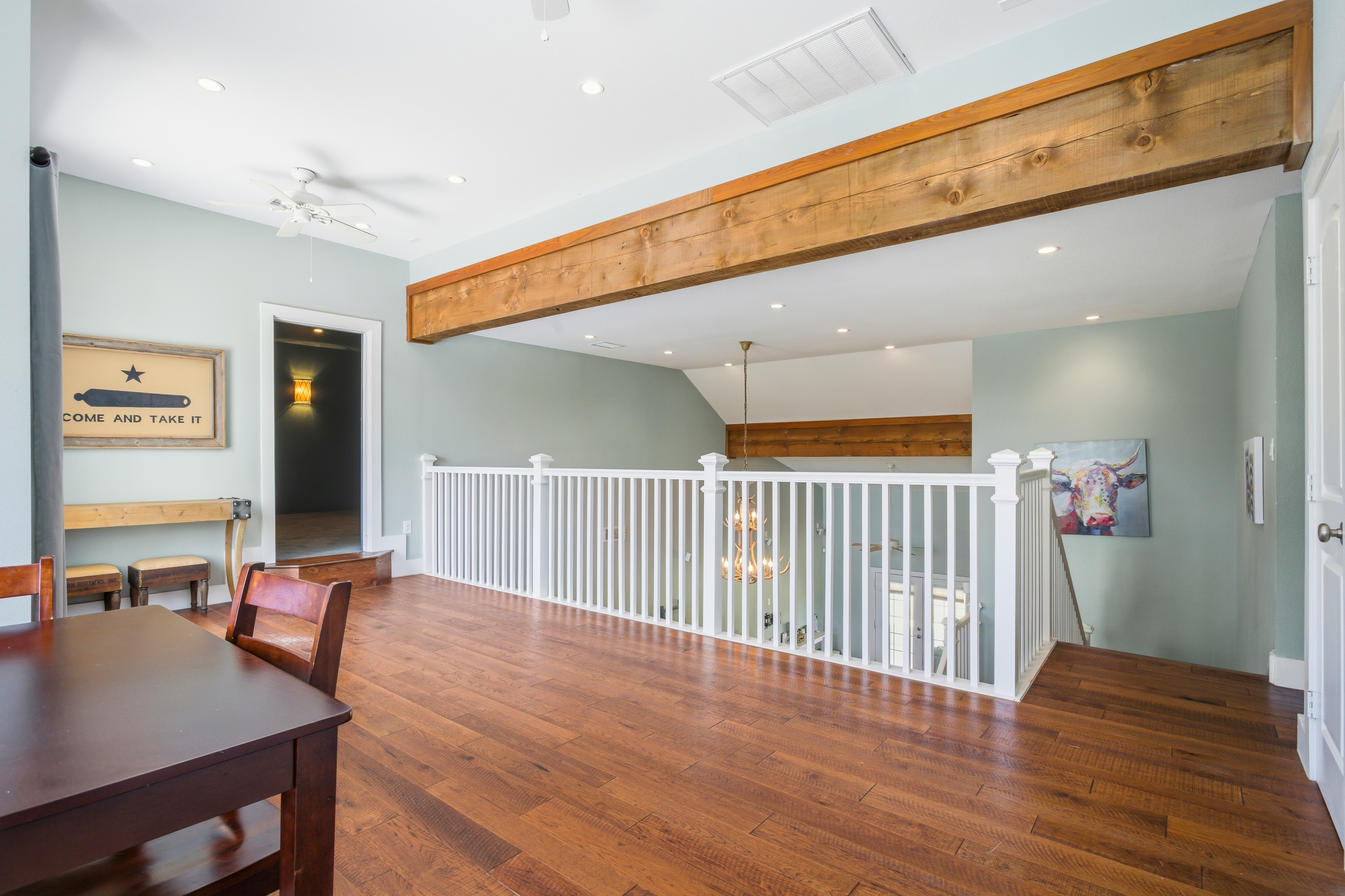 Upstairs landing with exposed timber beams and view to lower level