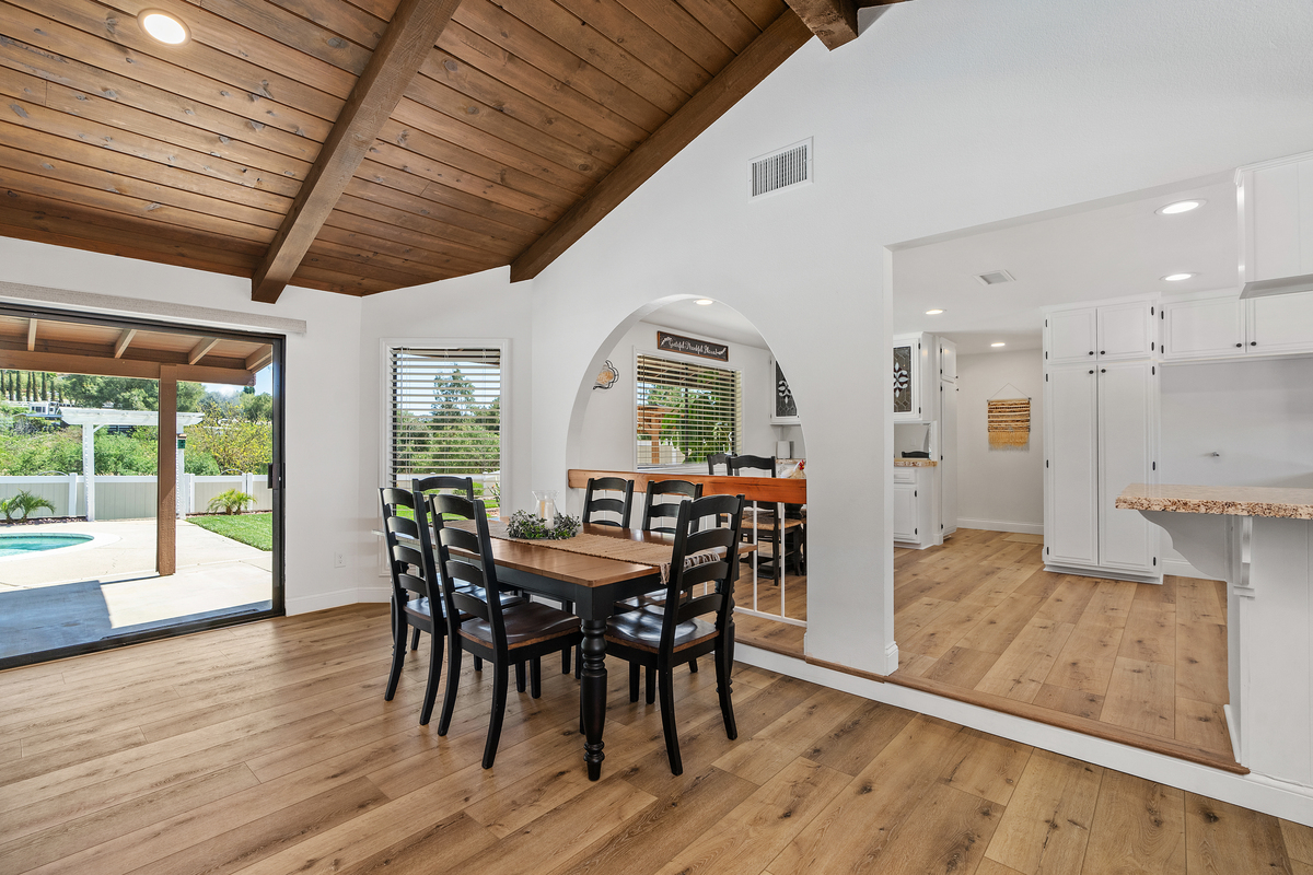 Dining room with arched wall opening and pool view