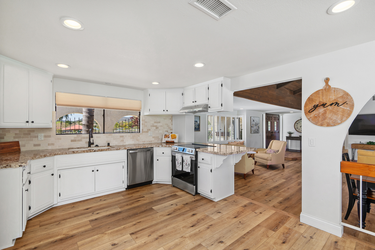Kitchen with stainless steel appliances and stone tile backsplash