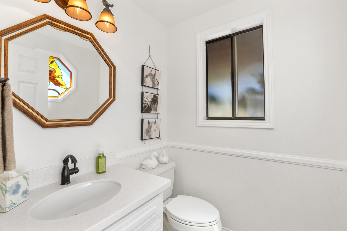 Bathroom vanity with hexagonal wood-framed mirror