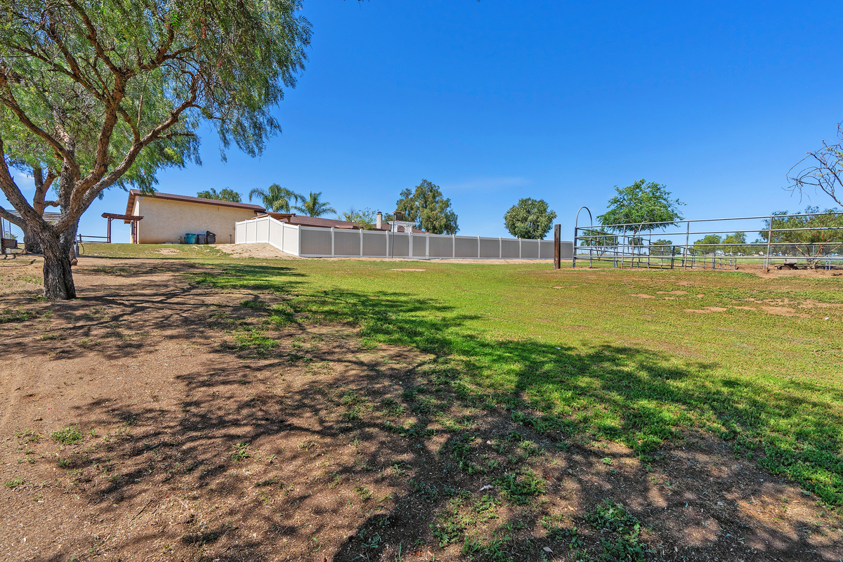 Rear property grounds with lawn and corrals