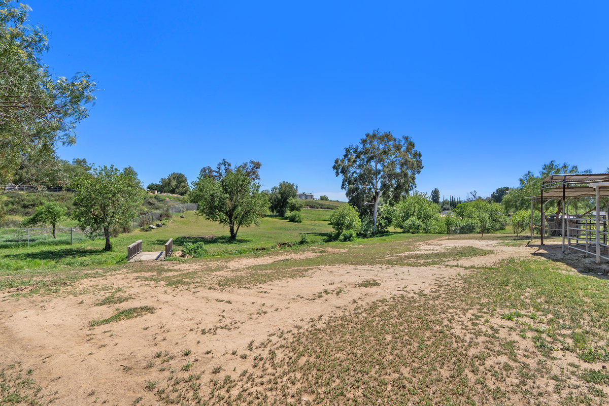 Property grounds with wooden bridge and creek