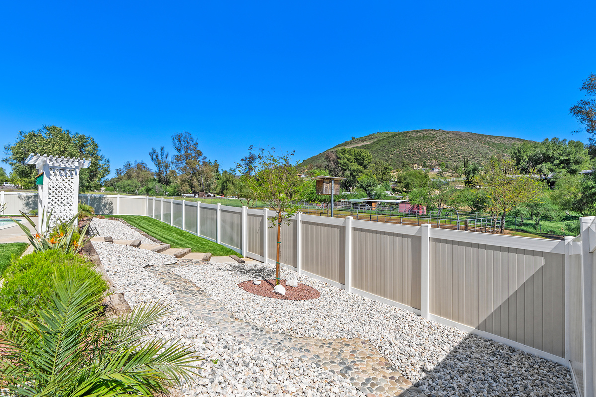 Vinyl fencing with riding arena view beyond