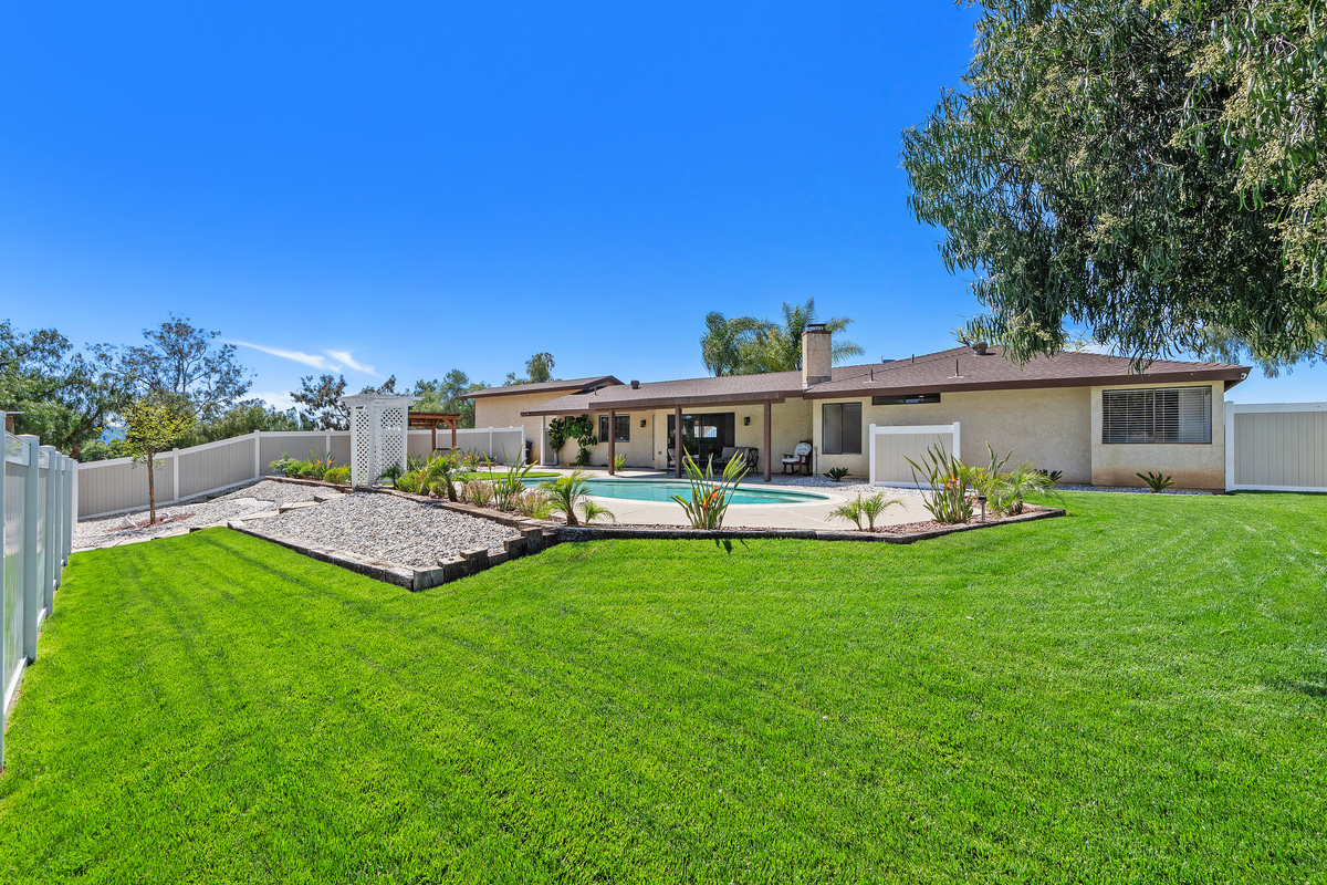 Pool with landscaped lawn and patio