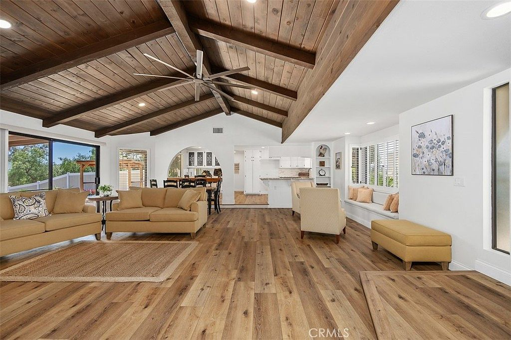 Living room with vaulted ceilings and patio doors