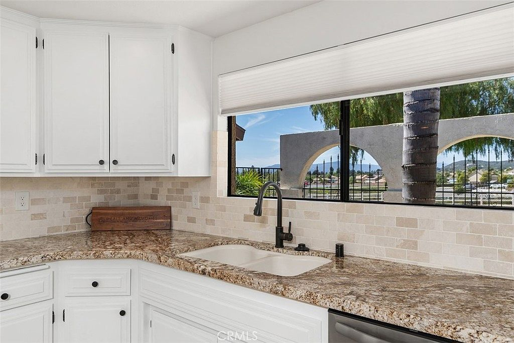 Kitchen sink area with large landscape window