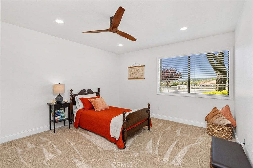 Secondary bedroom with patterned carpet