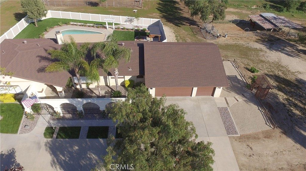 Aerial showing ranch estate with pool and corral