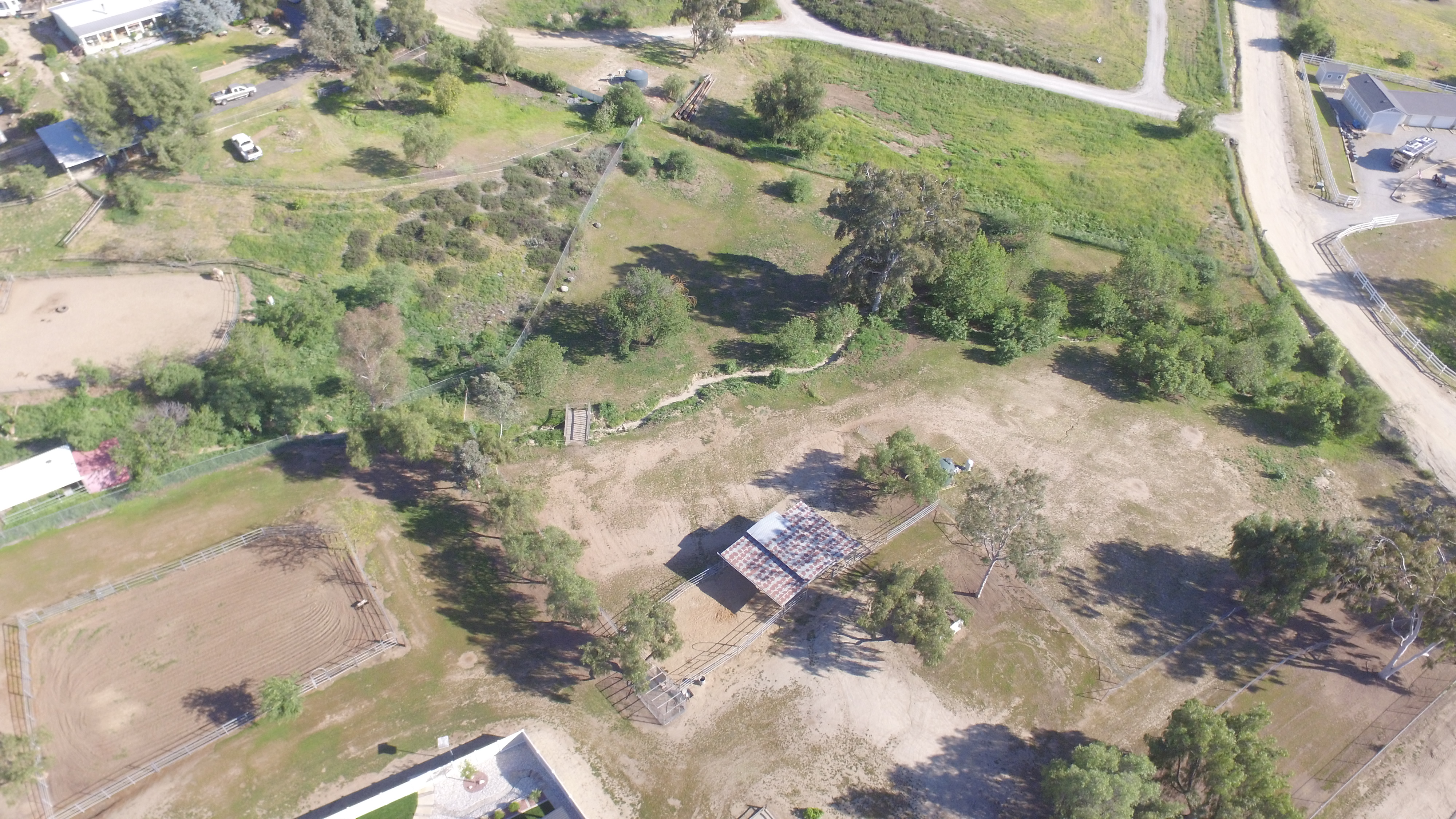 Aerial drone view of the 3.26-acre estate showing the home, pool, and equestrian facilities