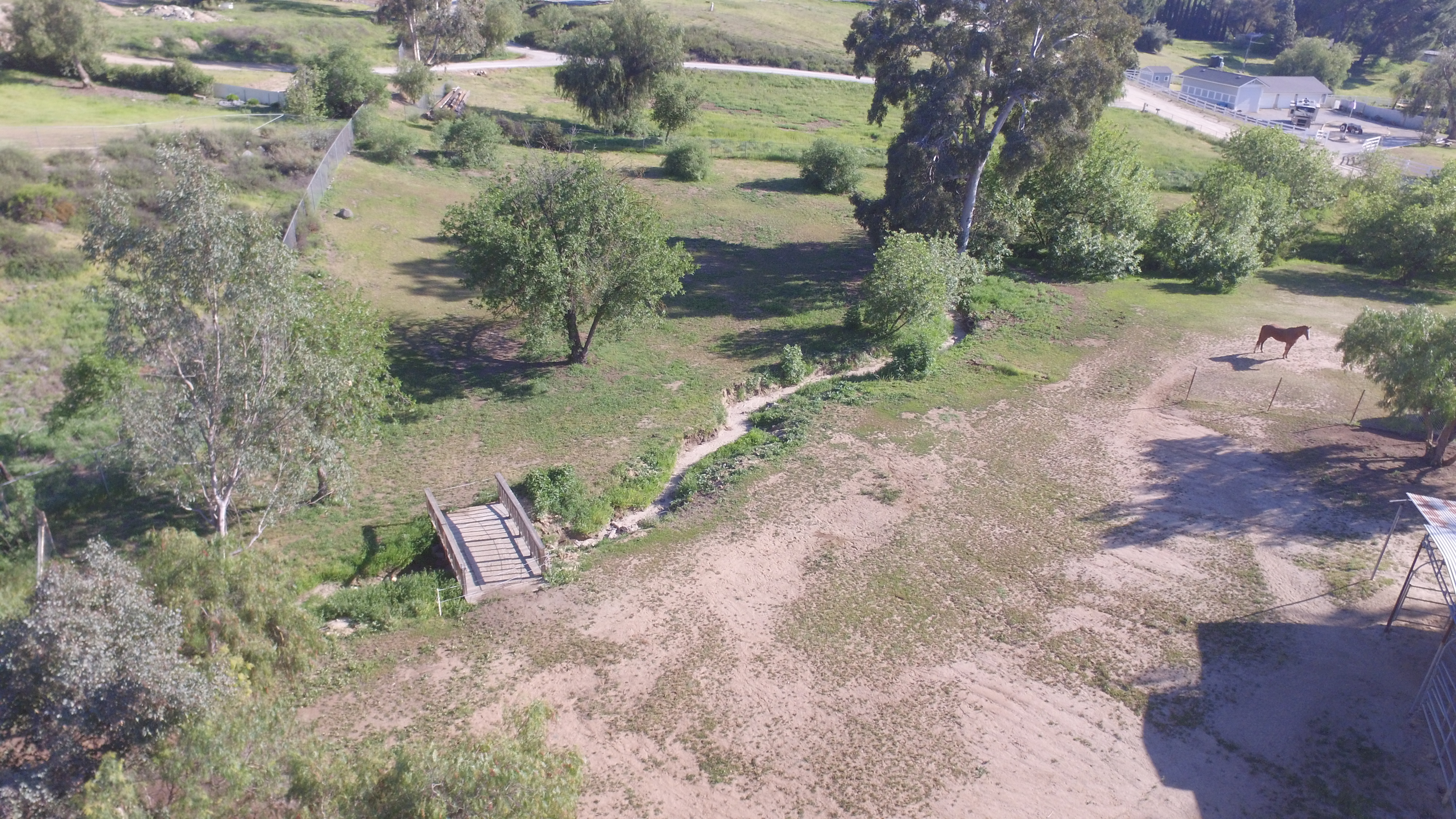Aerial of 3.26-acre property with creek and bridge