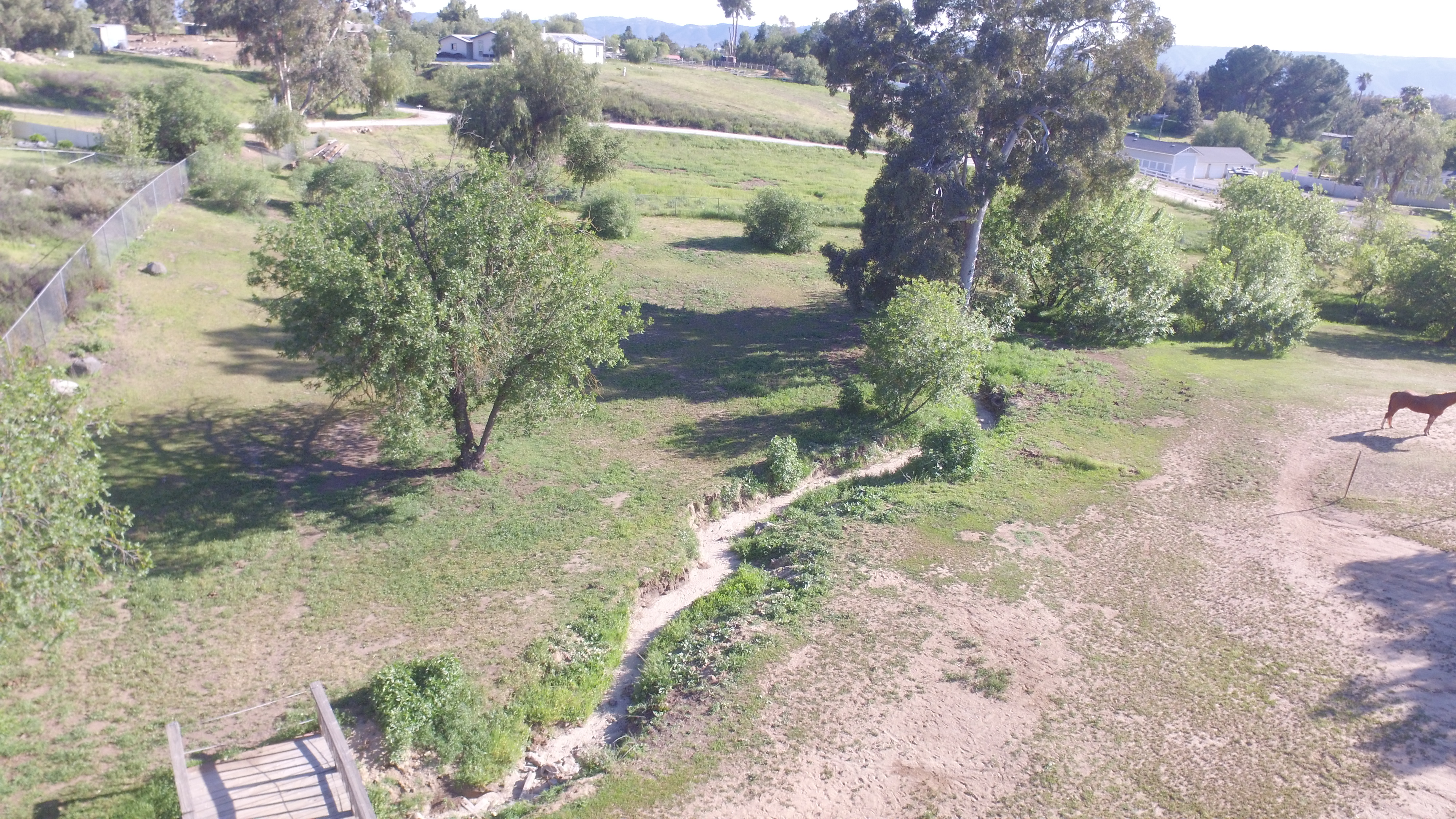 Aerial view of seasonal creek and open land