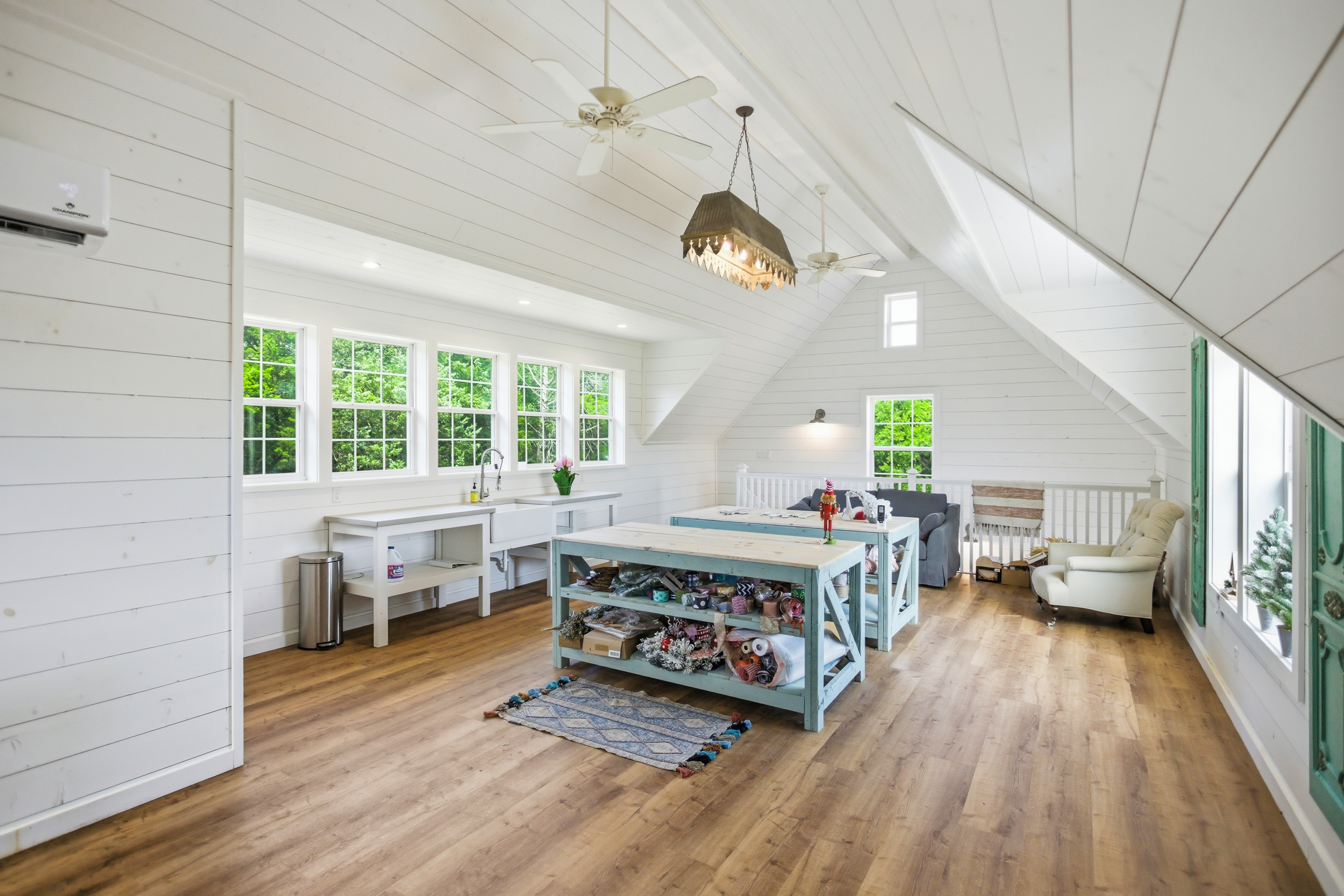 Finished guest cottage living area with vaulted ceilings and shiplap walls