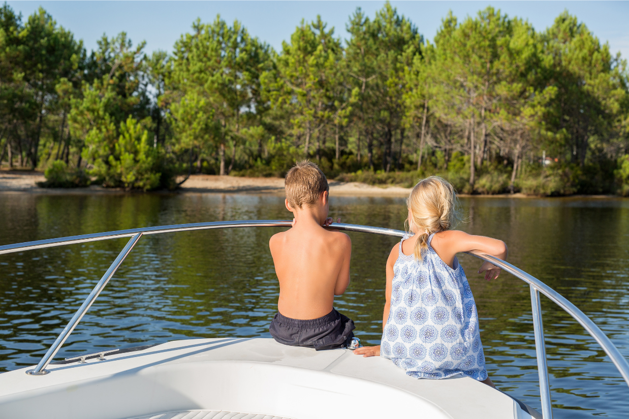 Kids sitting in the front of a boat looking out at Lake Murray in Irmo, South Carolina