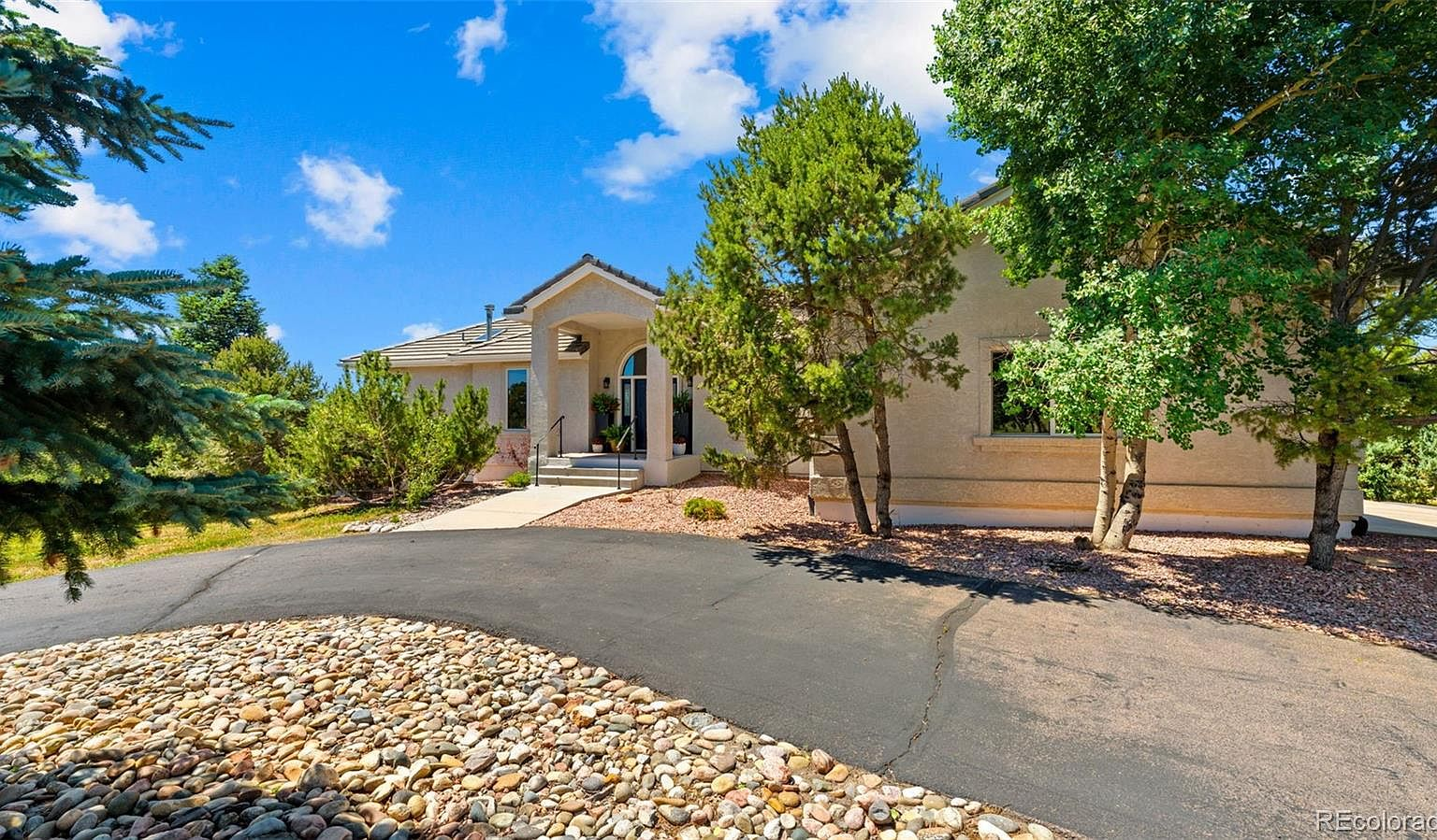 Front facade with curved driveway and xeriscape