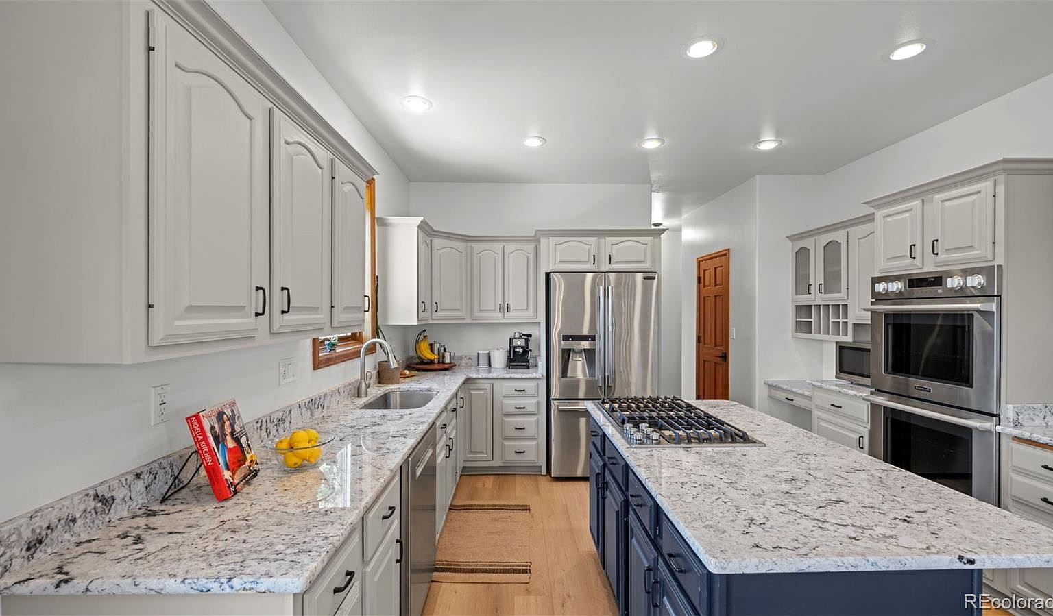 Kitchen with granite countertops and navy island