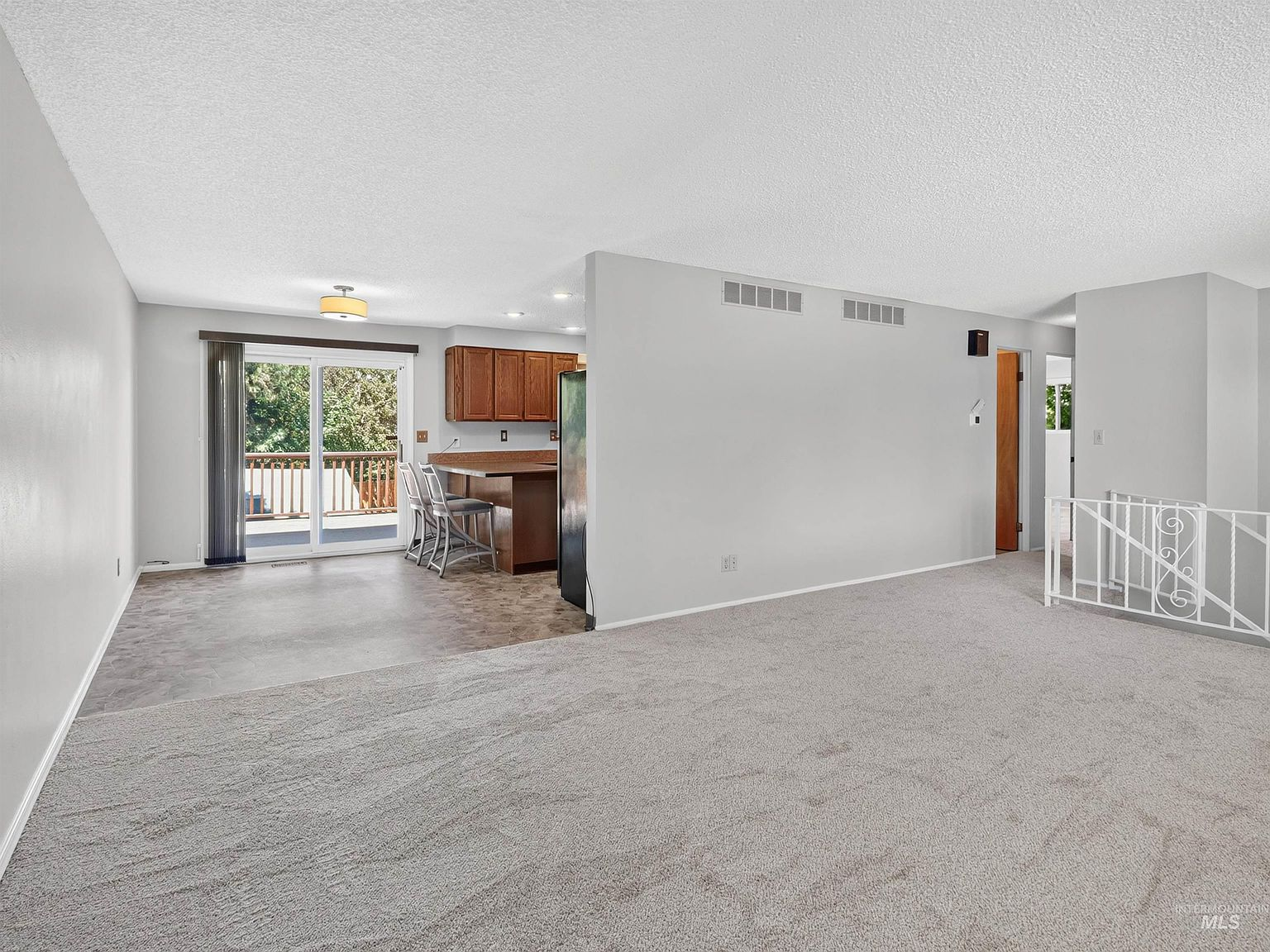 Open-concept main level connecting living area and kitchen
