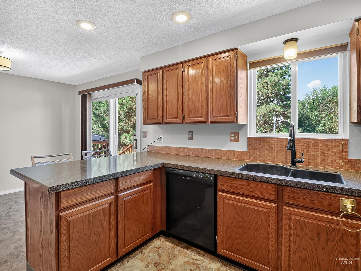 Kitchen perspective overlooking peninsula with oak cabinetry