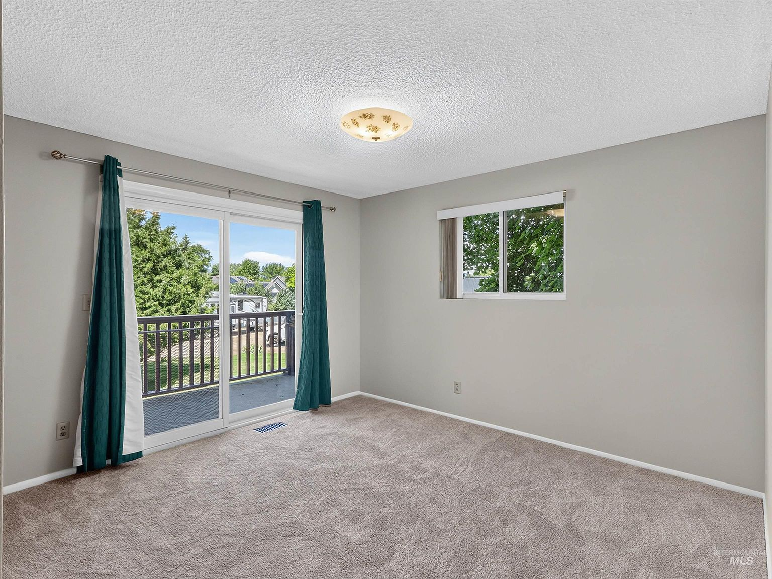 Primary bedroom with sliding glass door to private deck access