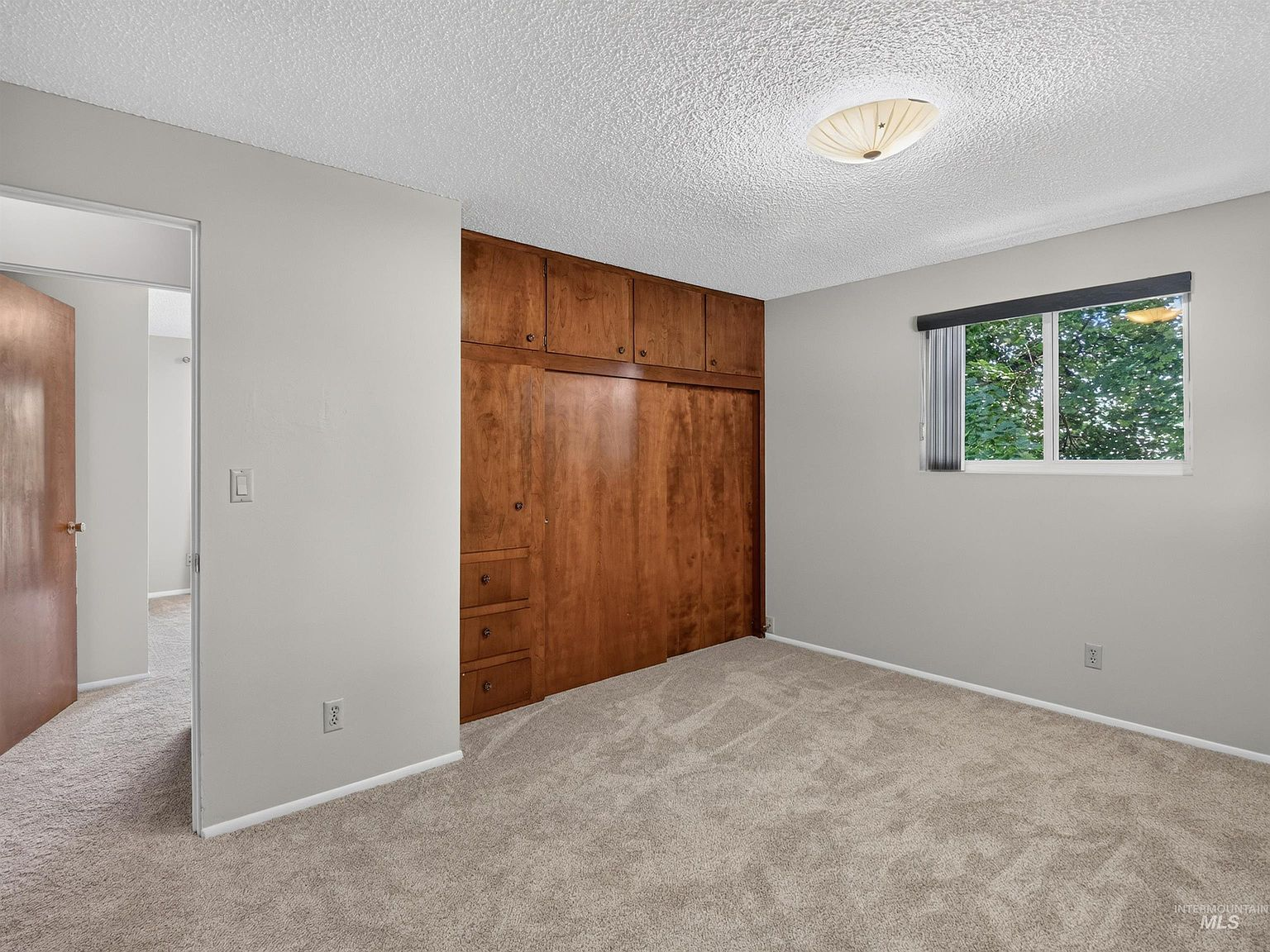Bedroom with built-in wooden wardrobe wall unit