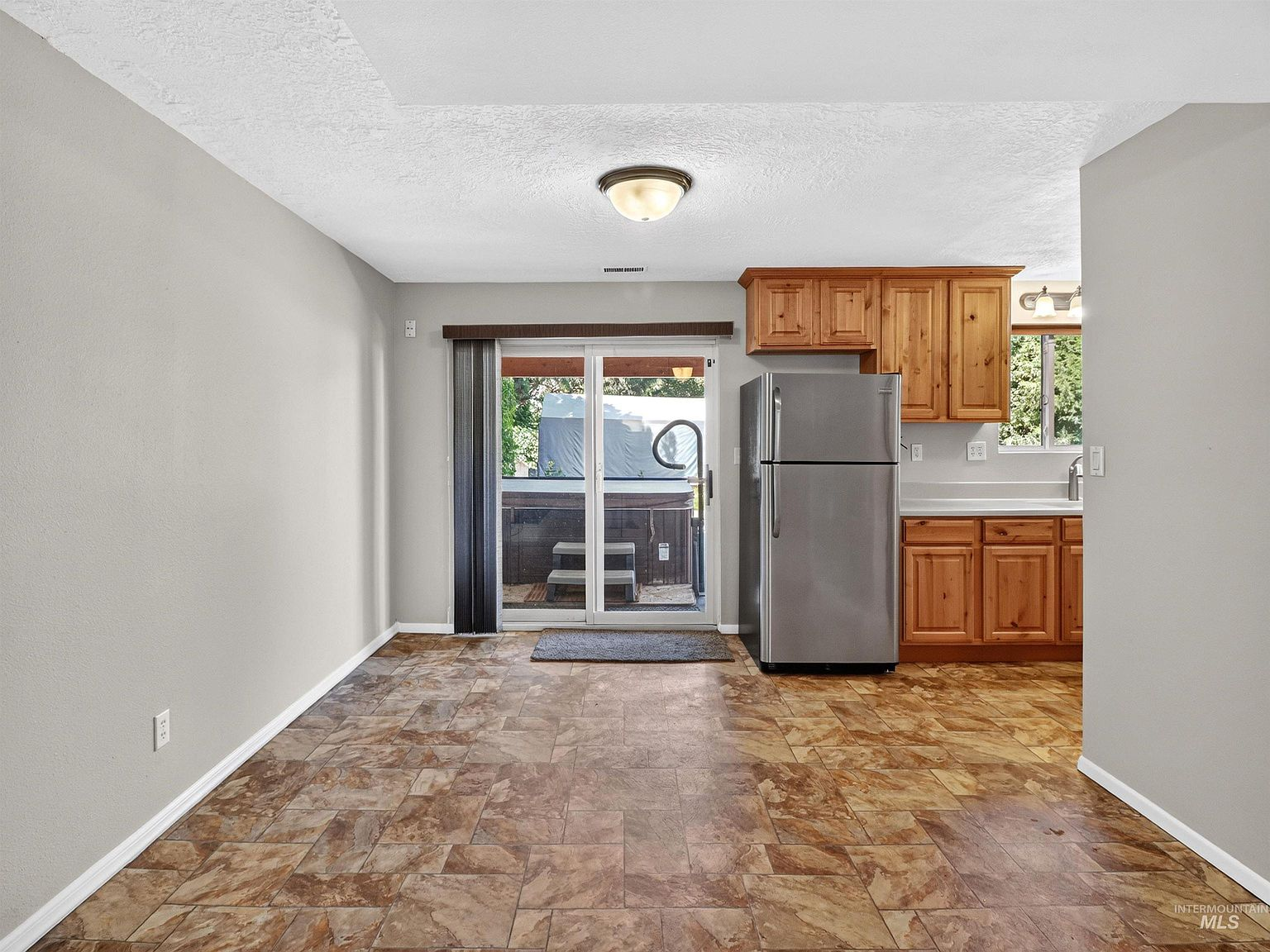 Lower-level kitchen with knotty pine cabinetry and dining area