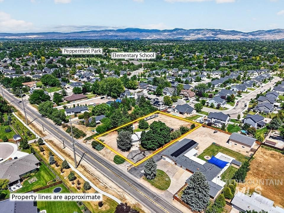 High-angle drone shot capturing the property lot with mountain views
