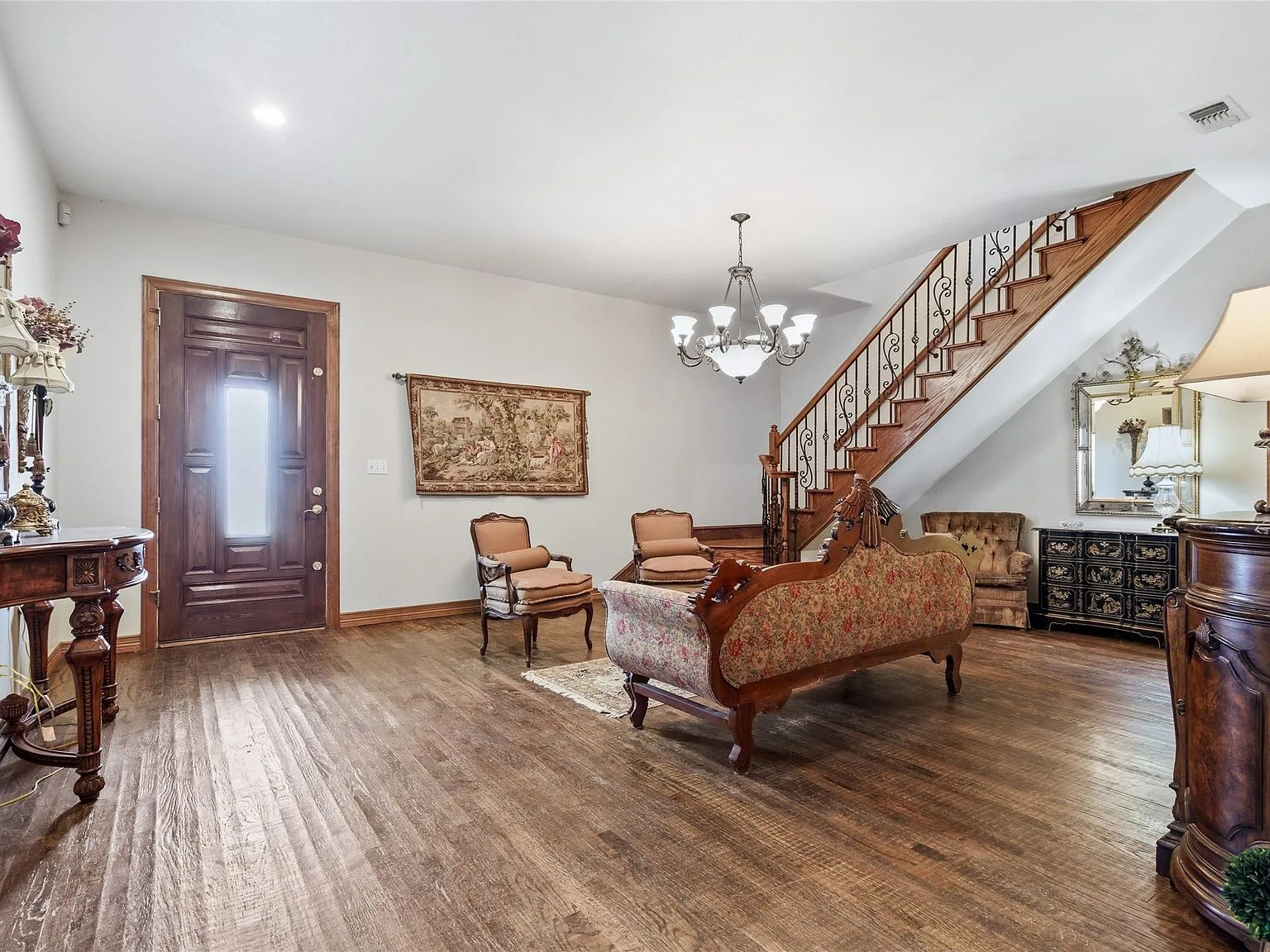 Entry foyer with hardwood floors and dark wood front door