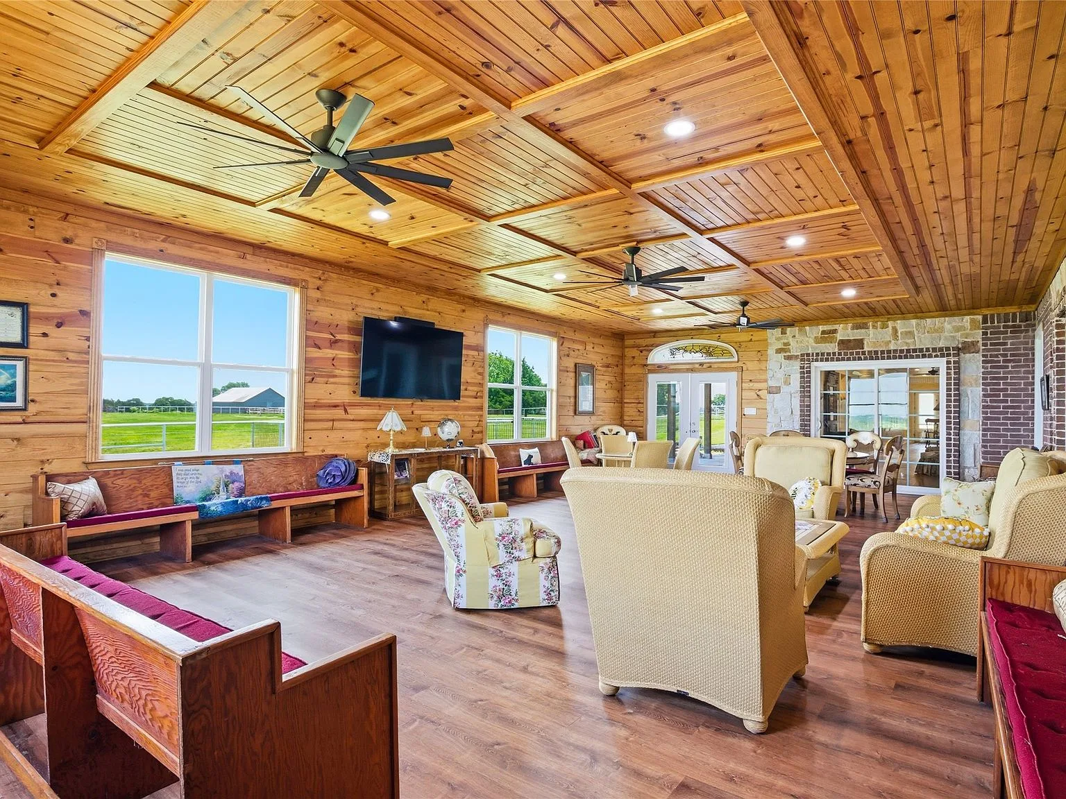 The Serenity Room interior with church pews, cedar coffered ceiling, and stone walls