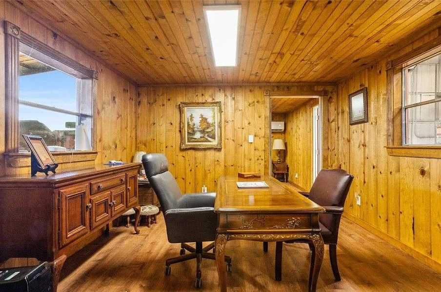 Wood-paneled home office with knotty pine walls