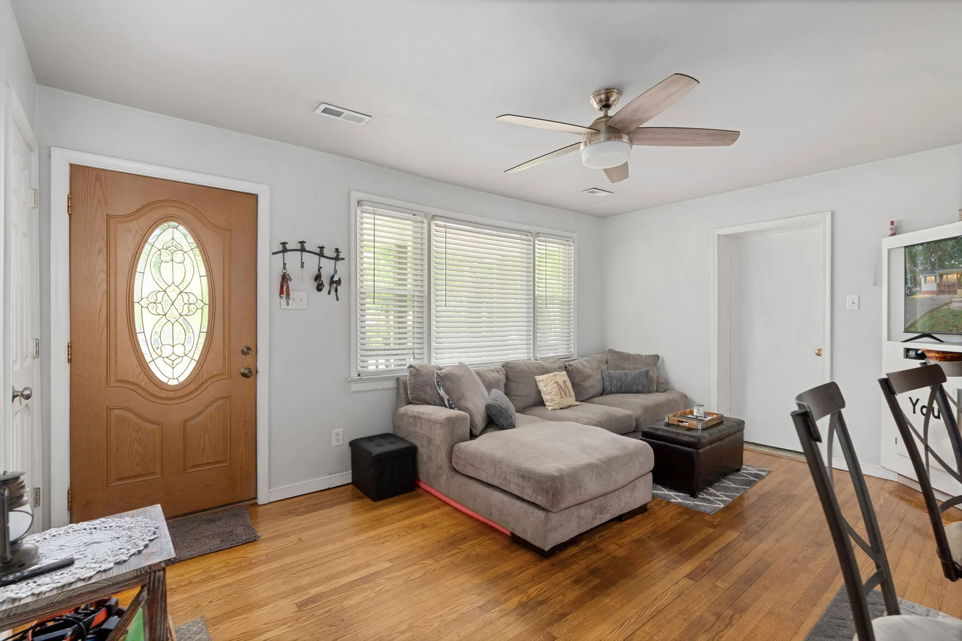 Living area with hardwood floors and front window