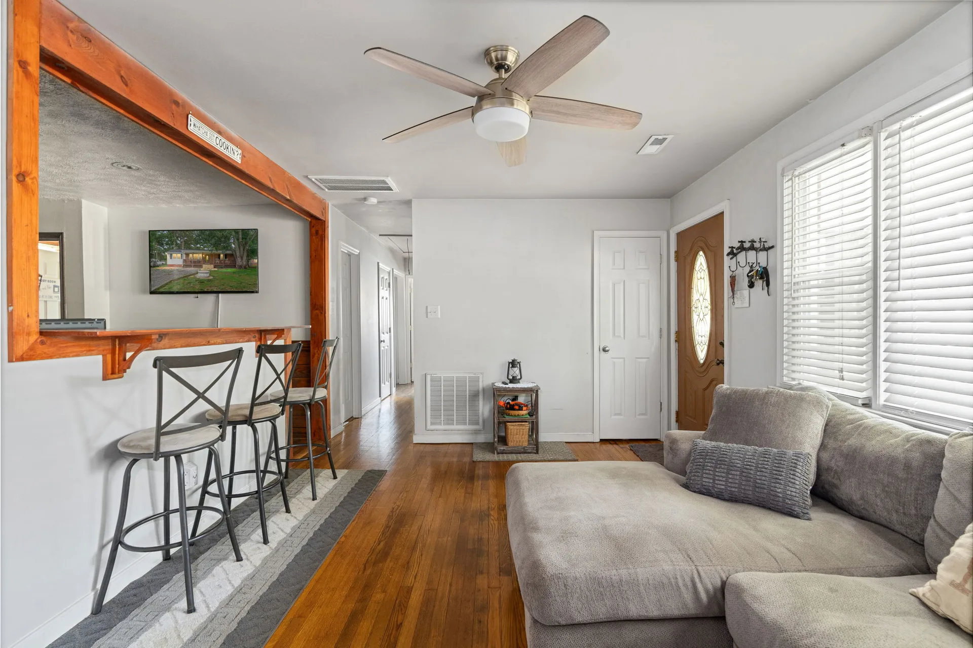 Open-concept living area with breakfast bar and hardwood floors