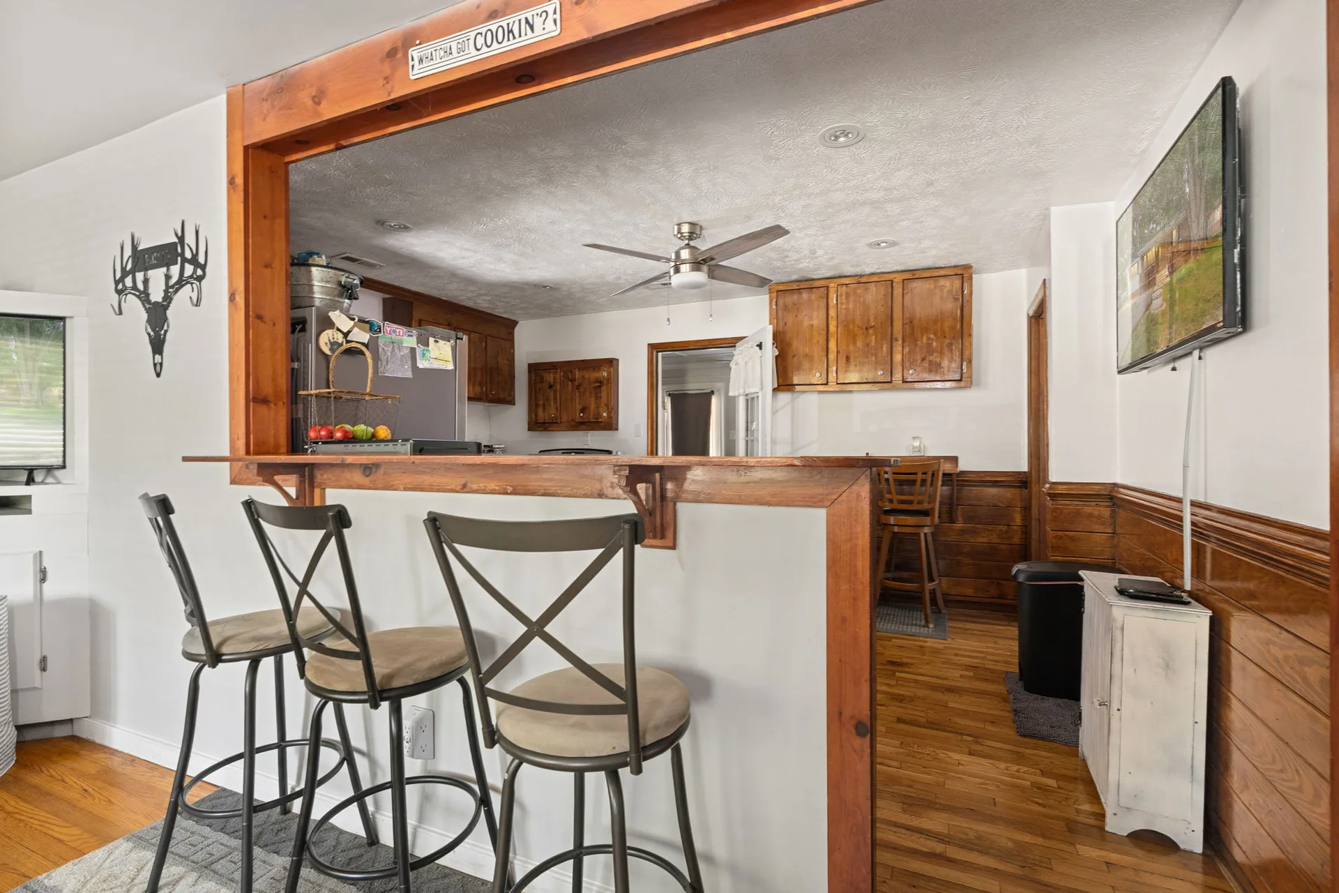 Kitchen viewed through pass-through bar from living area