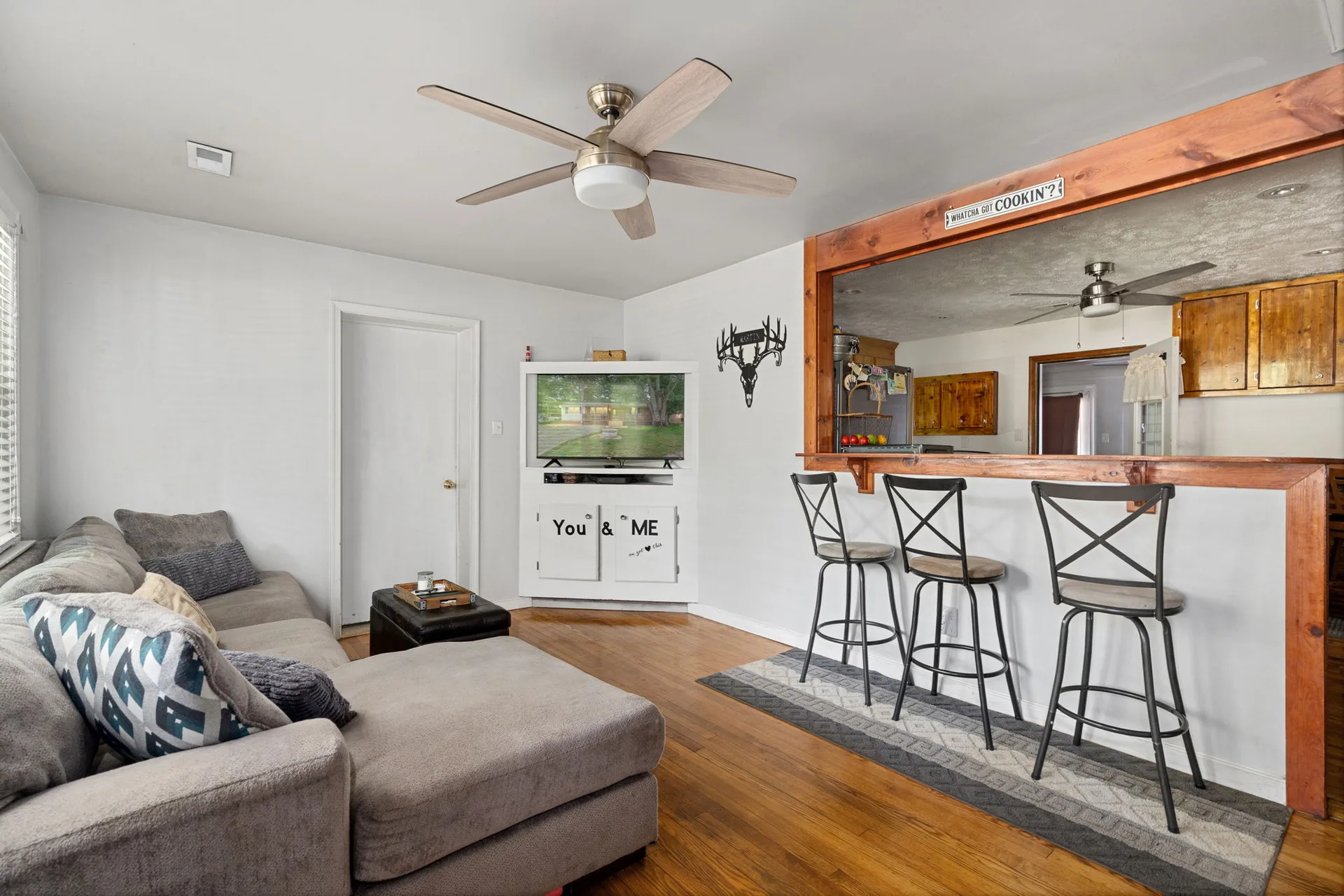 Living and dining space with kitchen pass-through and bar seating