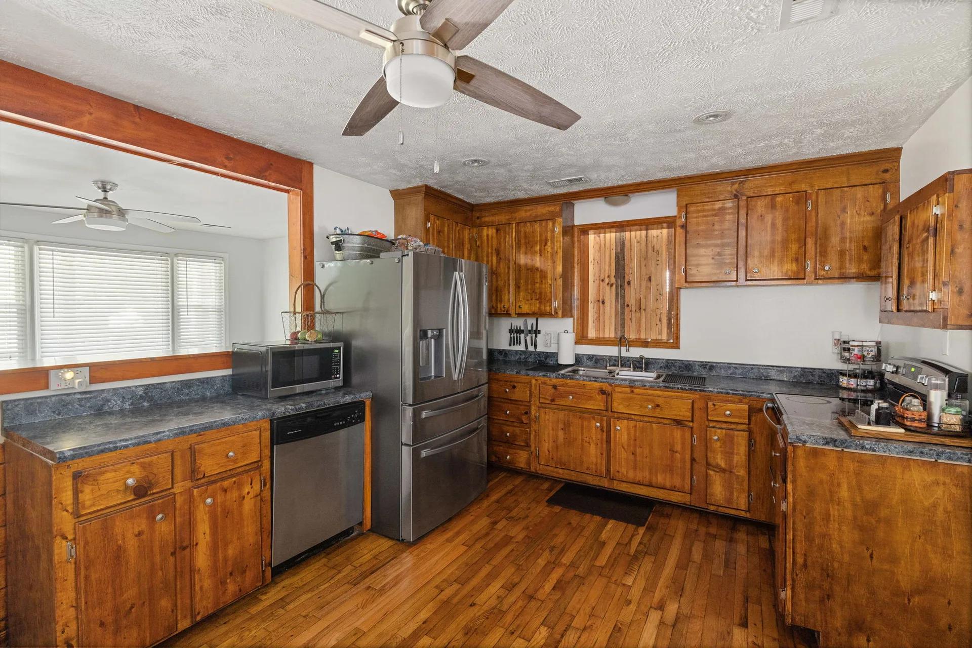 Kitchen with warm wood cabinetry and stainless steel appliances
