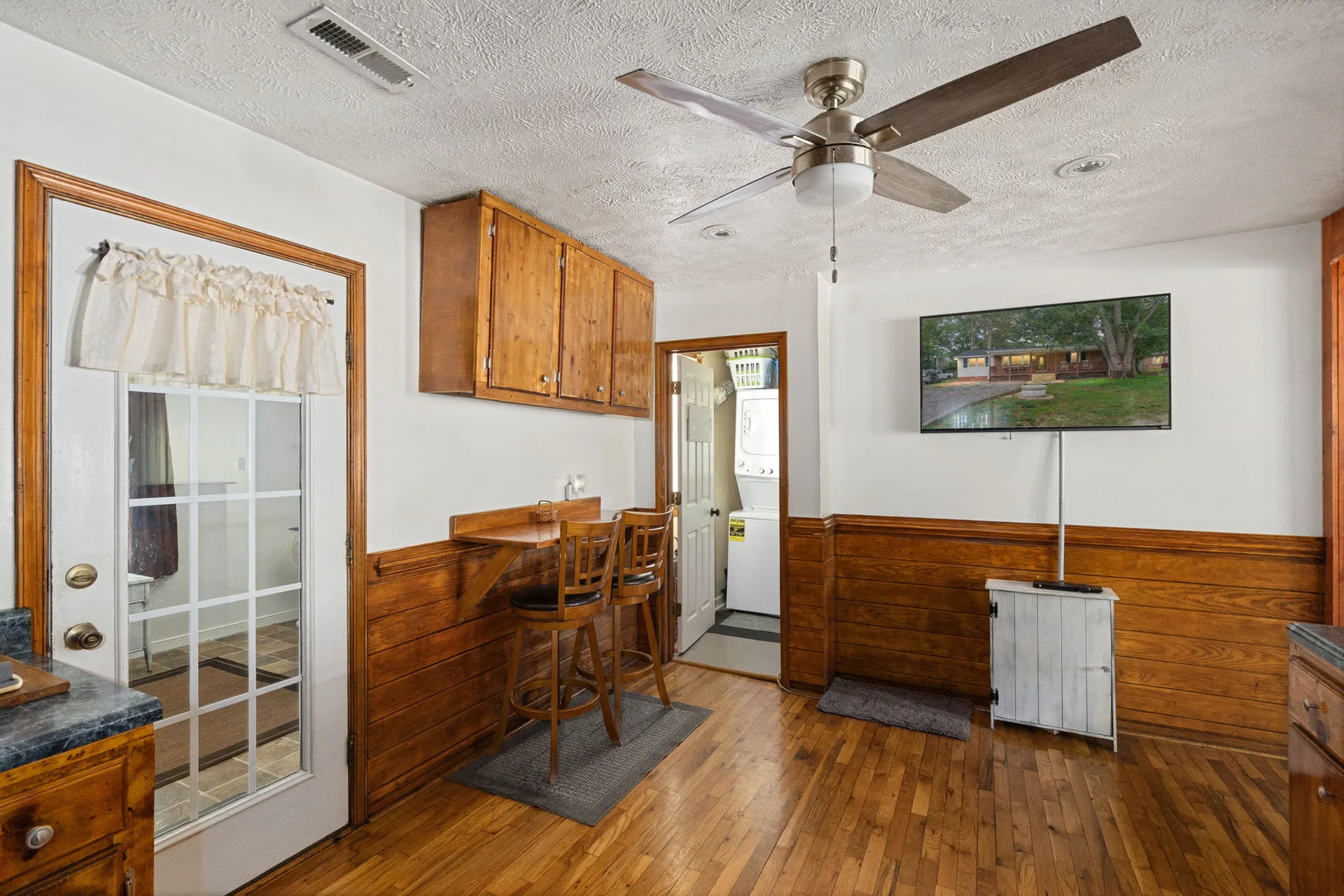 Kitchen eat-in nook with wood wainscoting and breakfast bar