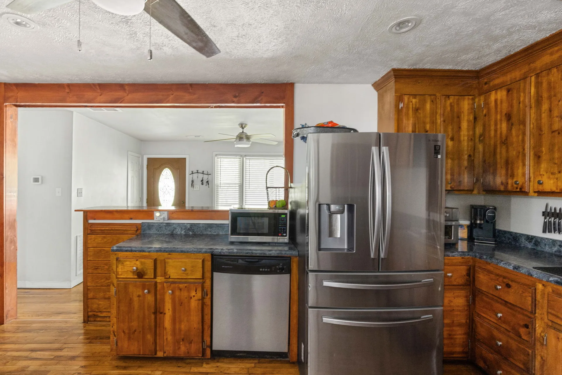 Kitchen view through pass-through opening into the living area