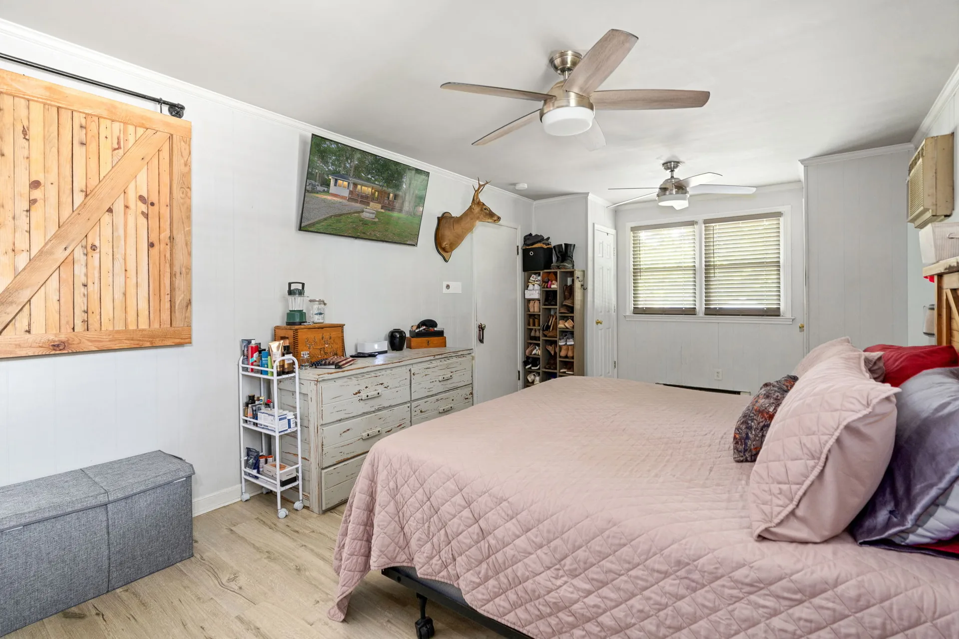 Master bedroom wide-angle view with barn door accent