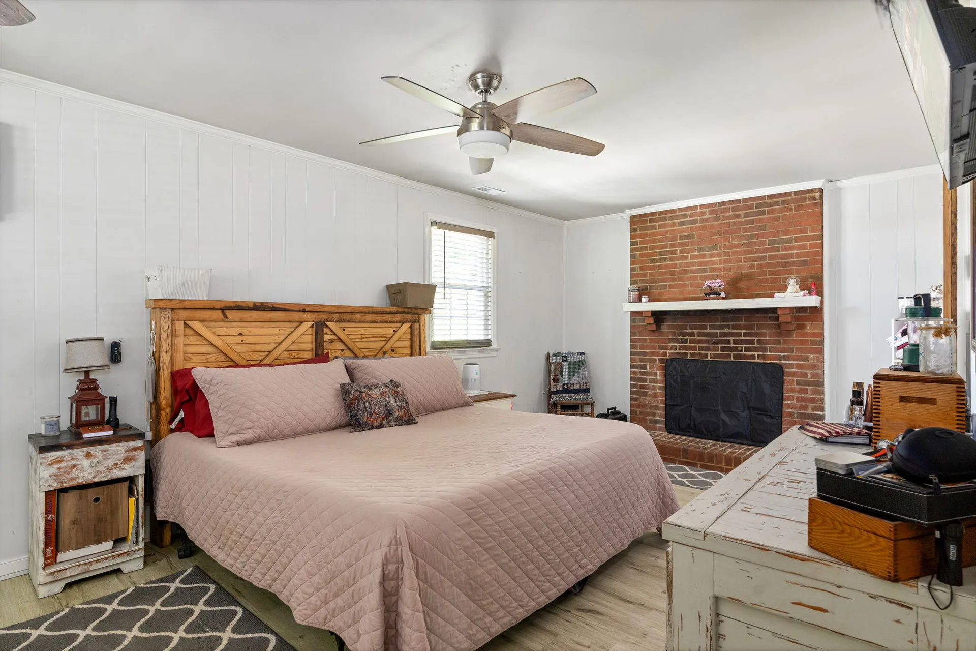 Primary bedroom with brick fireplace