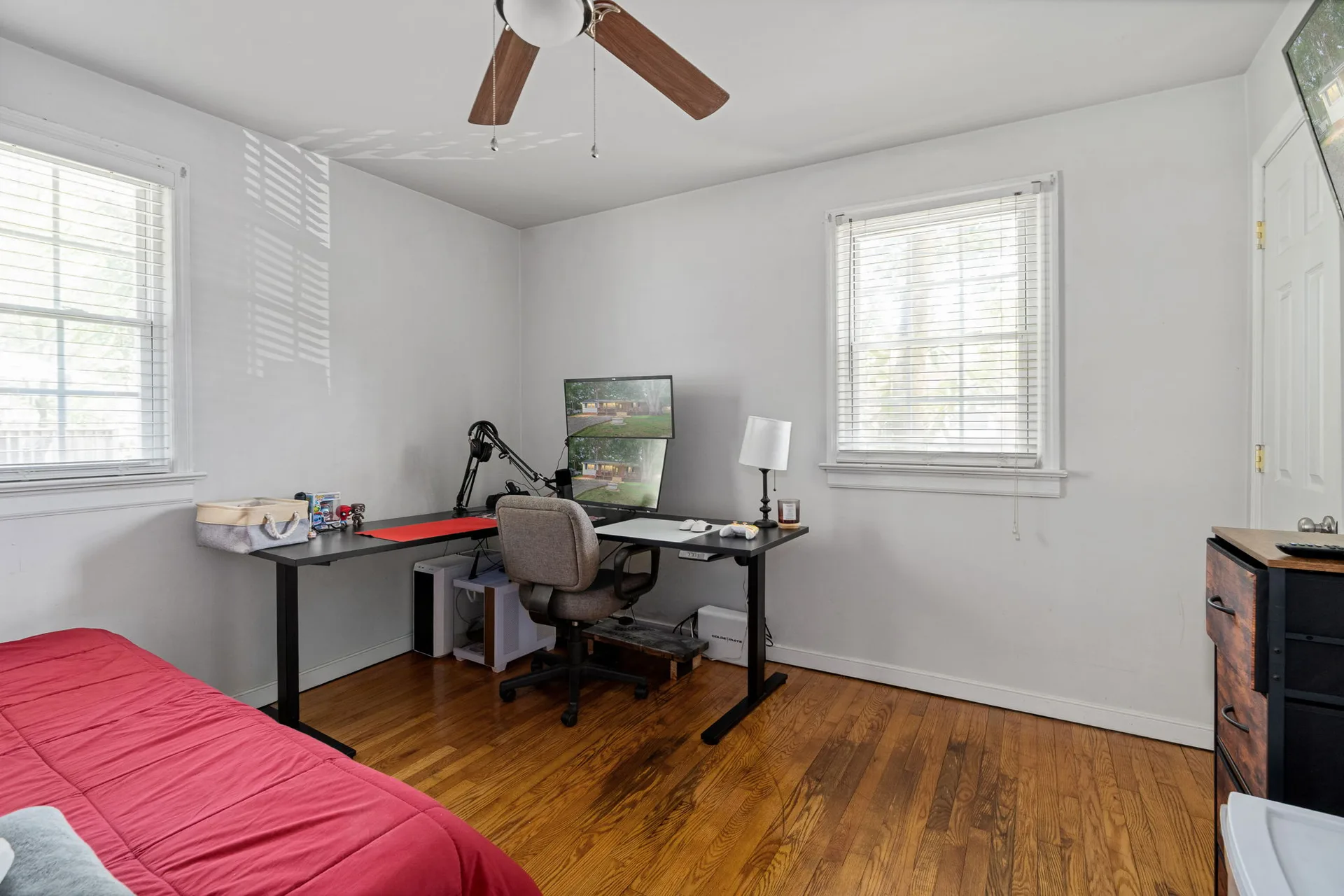 Bedroom configured as a workspace with desk and monitors