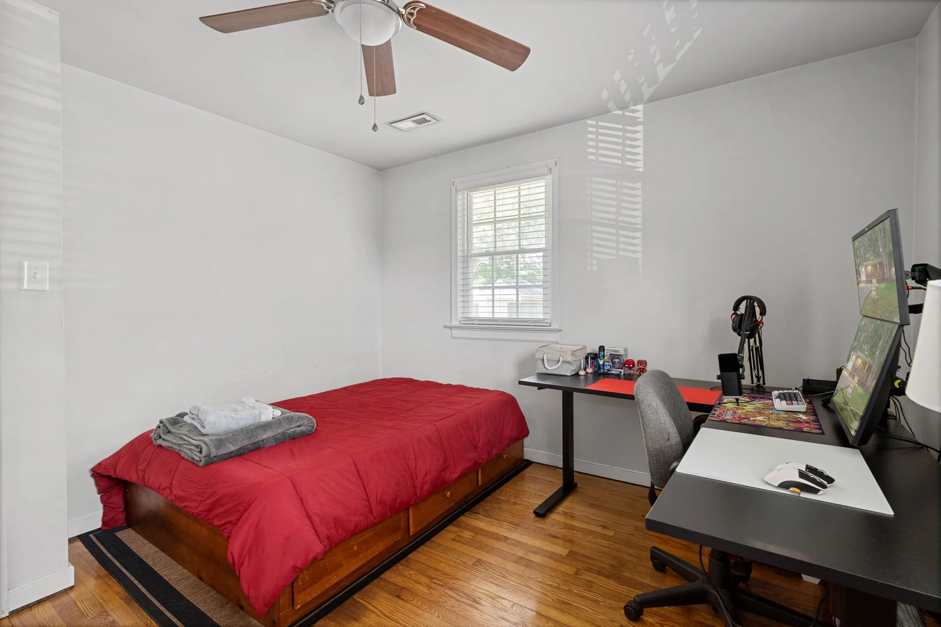 Secondary bedroom with bed and office setup