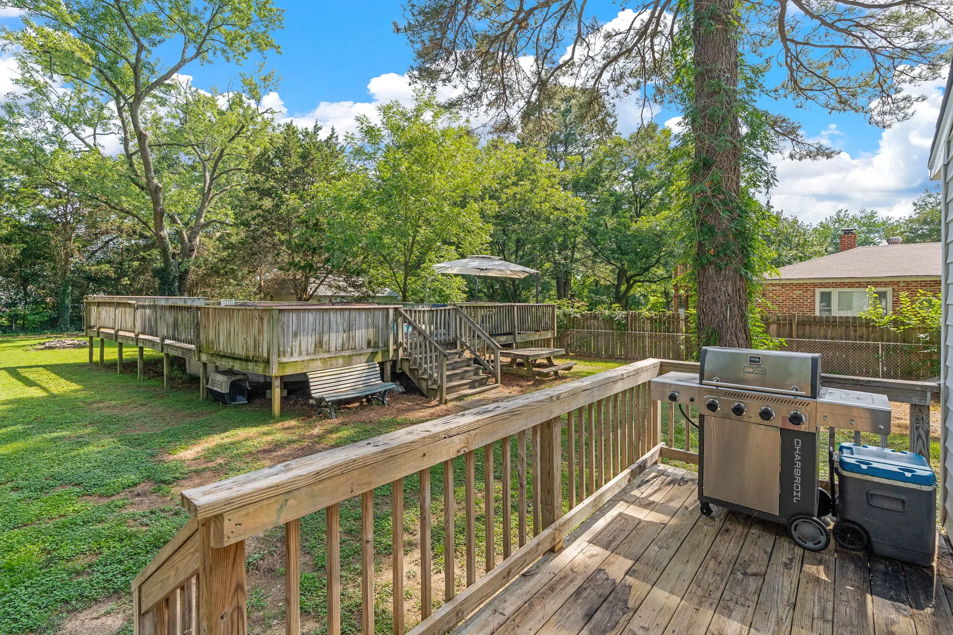Backyard with elevated wood deck and large fenced yard