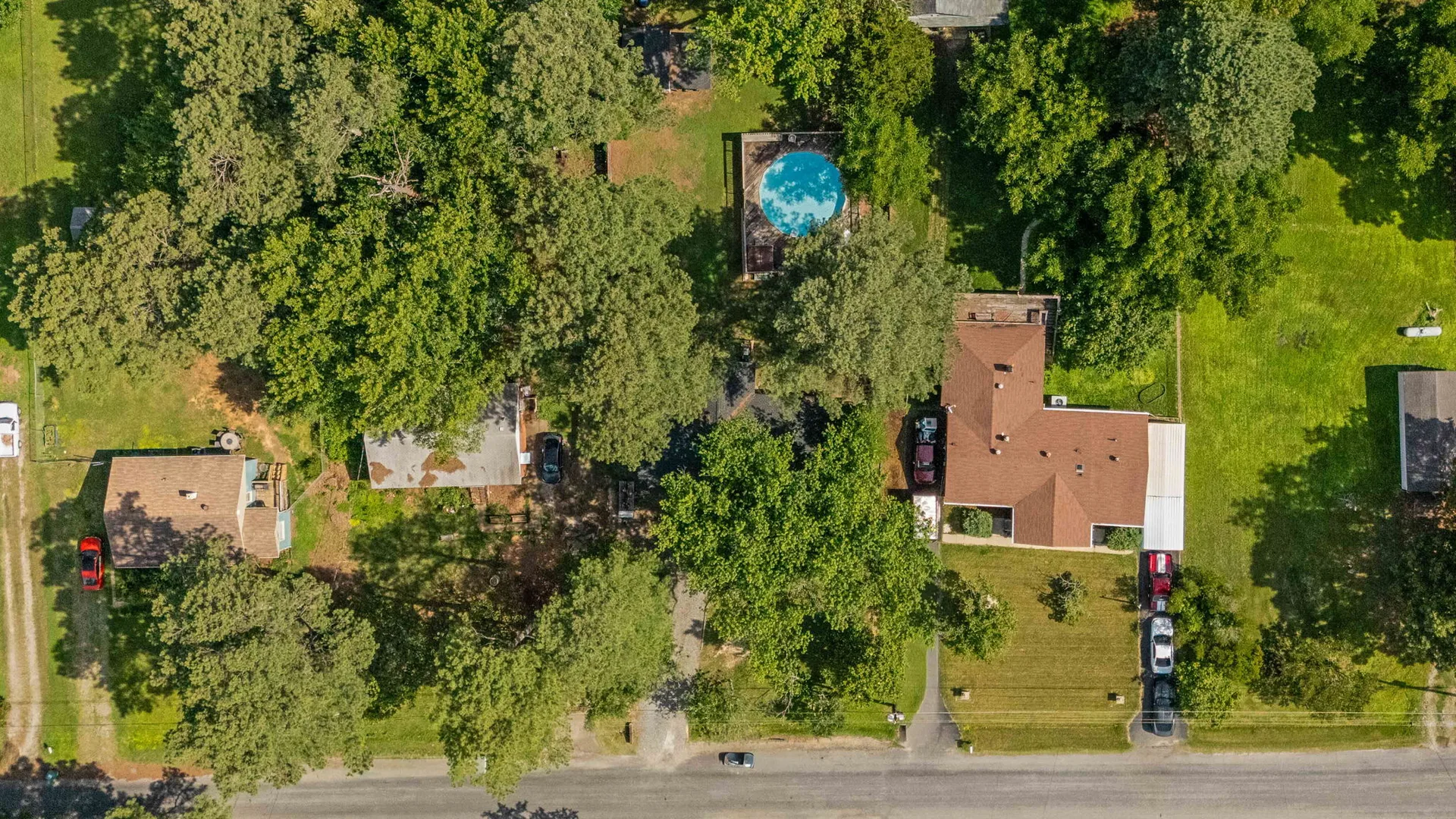 Aerial view of 1343 Bartlett Rd showing the 0.41-acre lot with pool, deck, and outbuilding