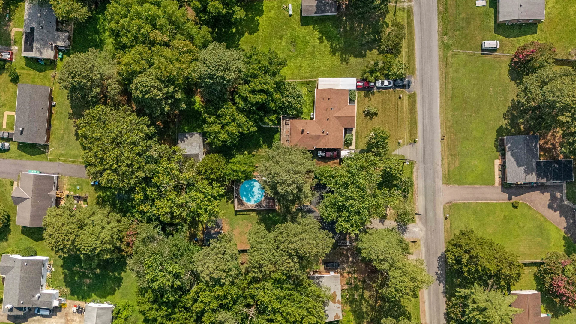 Top-down aerial view of ranch home, pool, and outbuilding
