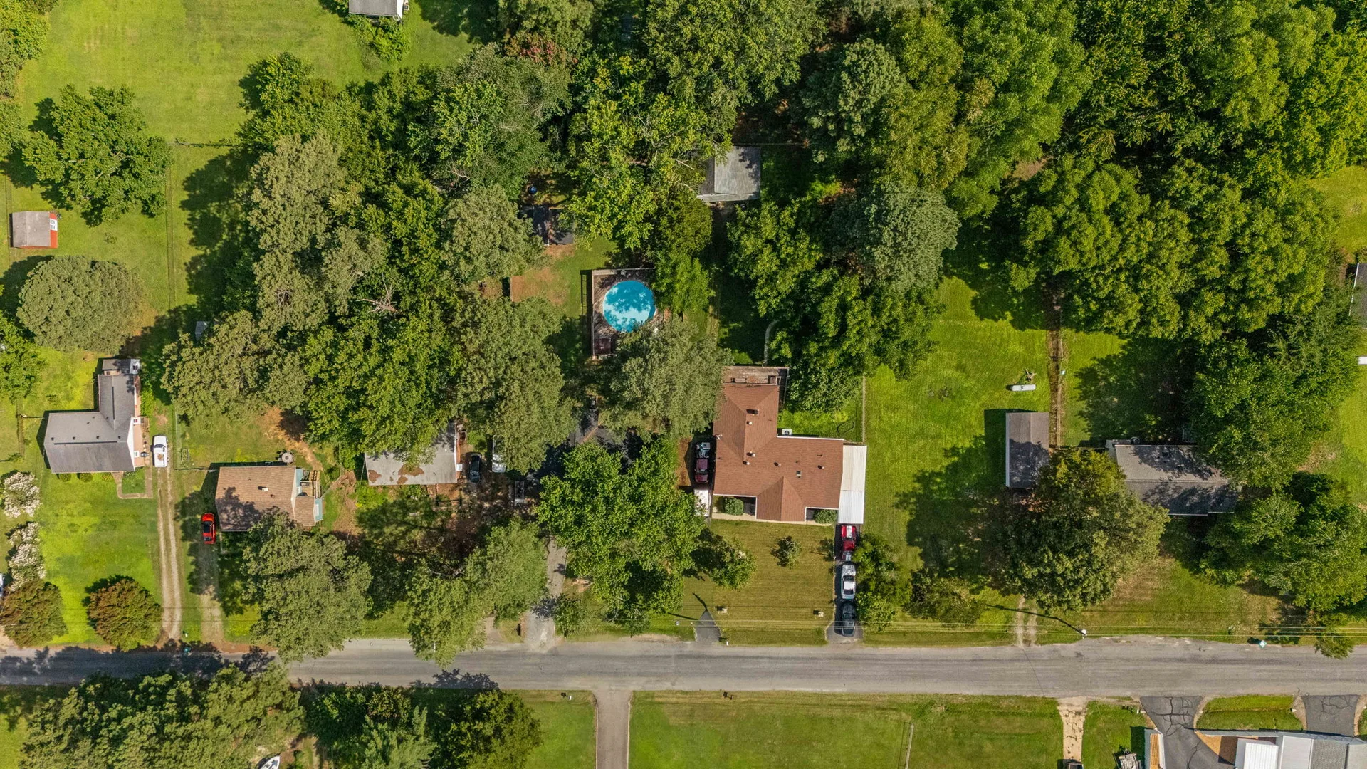 Aerial overview of full 0.41-acre lot with pool and fenced yard