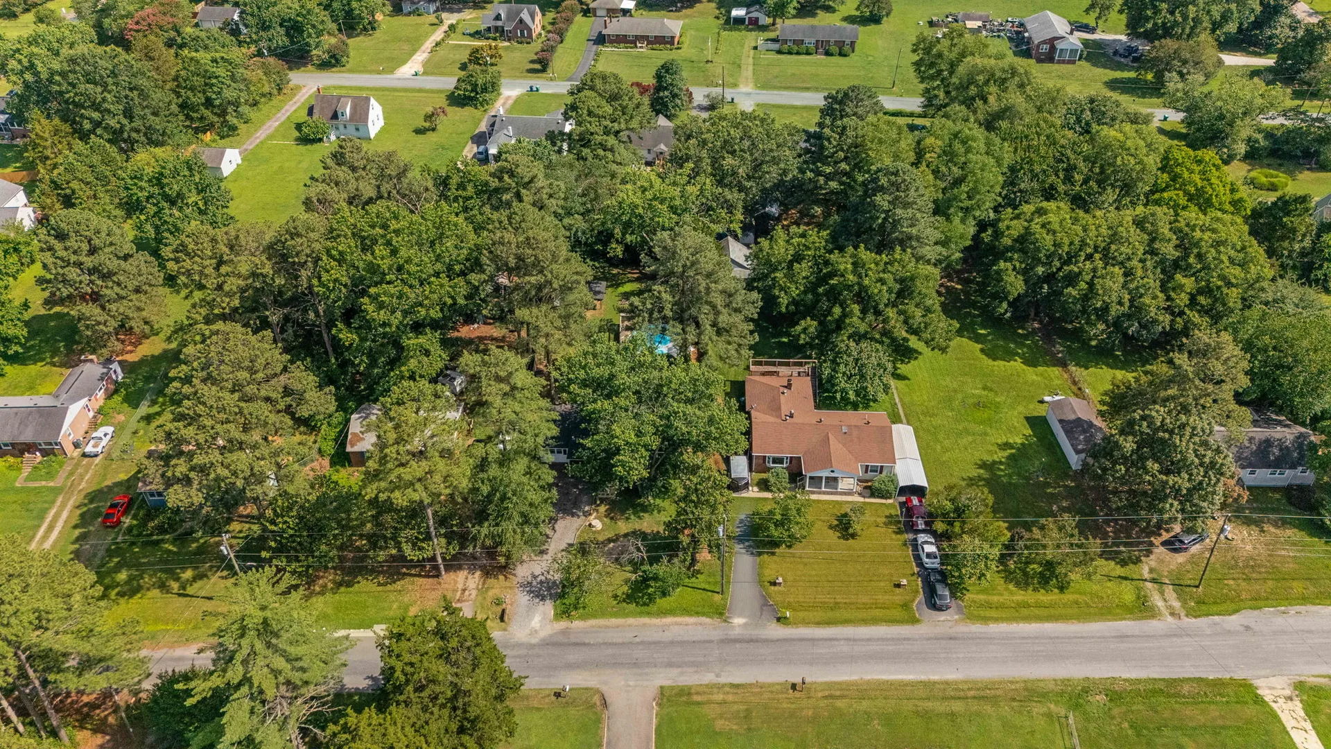 Bird's-eye drone view of the corner lot property and surroundings
