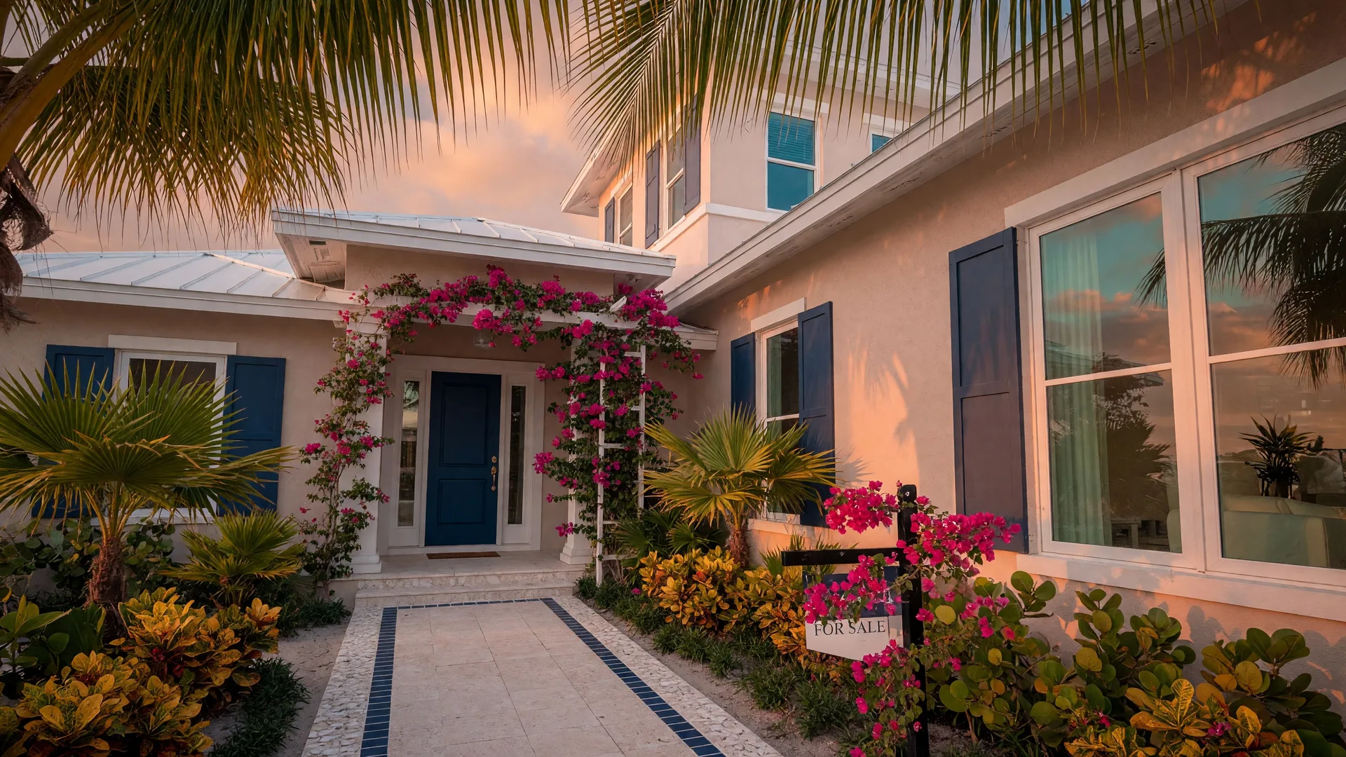 A modern coastal home in Southwest Florida at golden hour, with tropical landscaping and a welcoming entrance framed by palm trees and bougainvillea