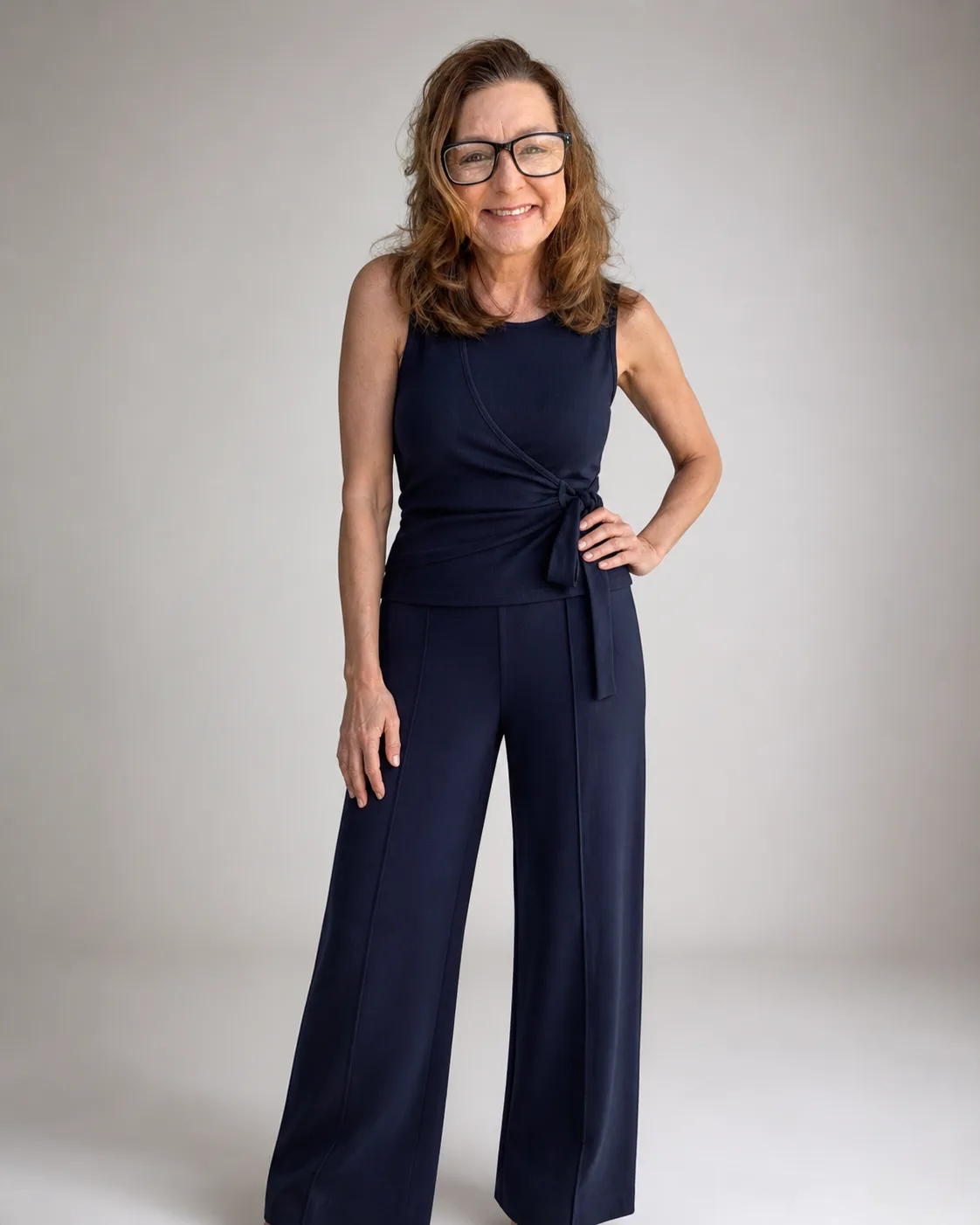 Kim Donahue in a navy sleeveless wrap top, professional portrait