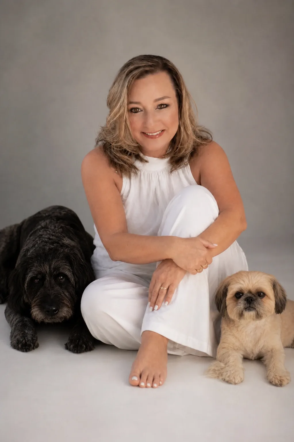 Kim Donahue sitting with her two dogs
