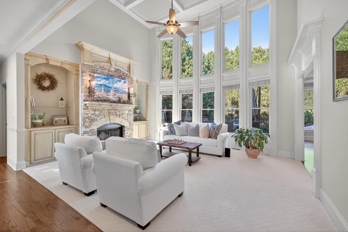 Living room with custom built-ins flanking the stone fireplace