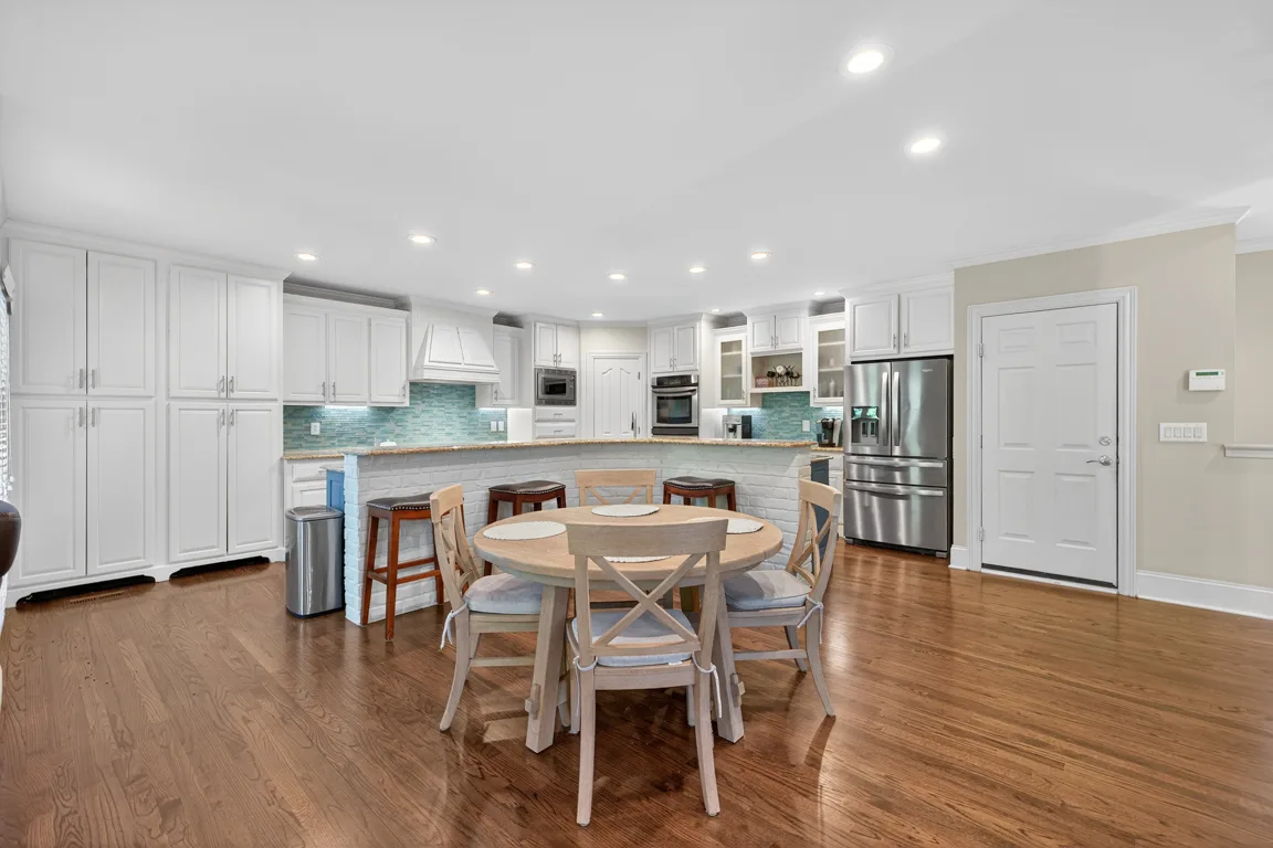 Kitchen with eat-in dining area and brick island detail